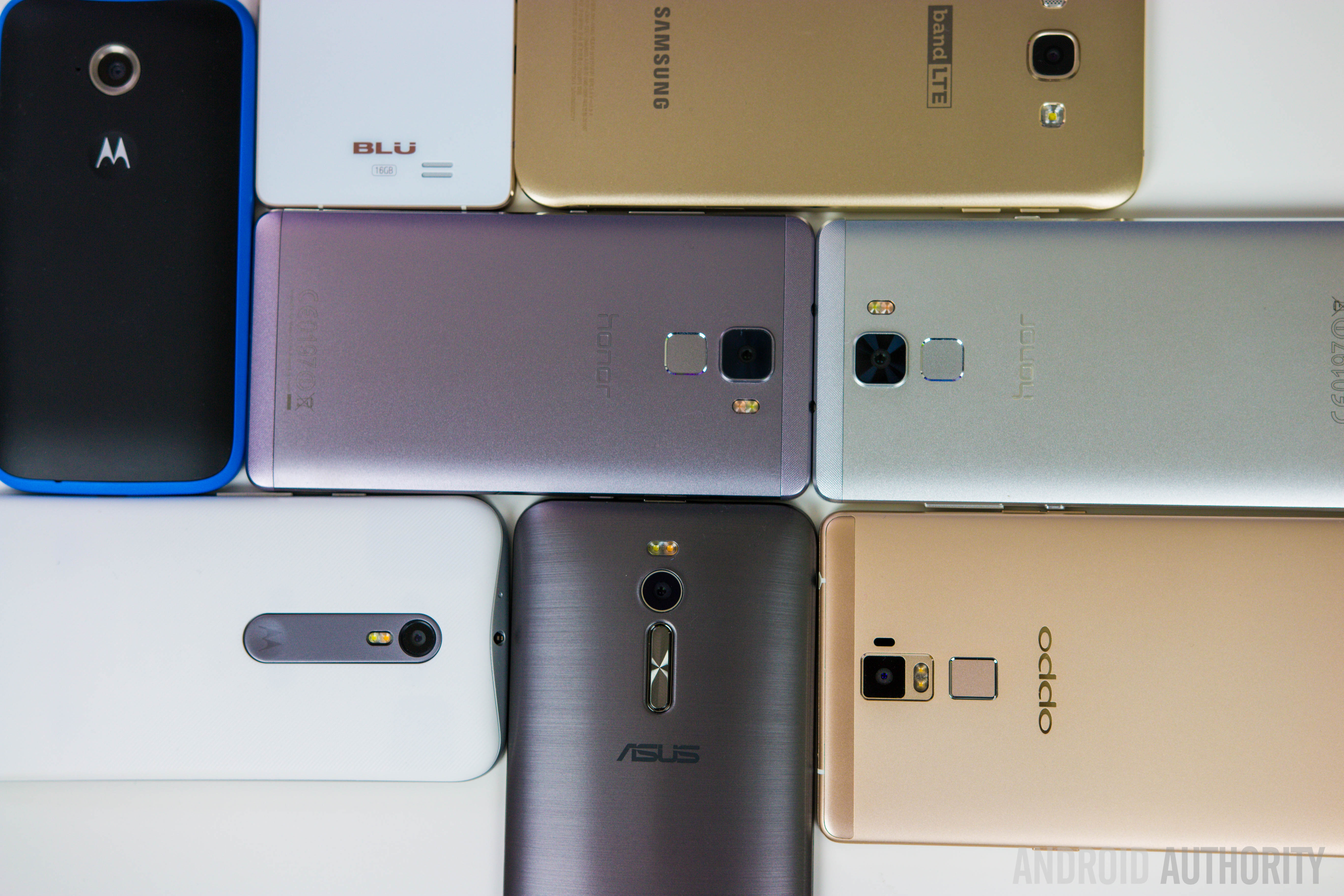 Different Android smartphones stacked with the back side up.