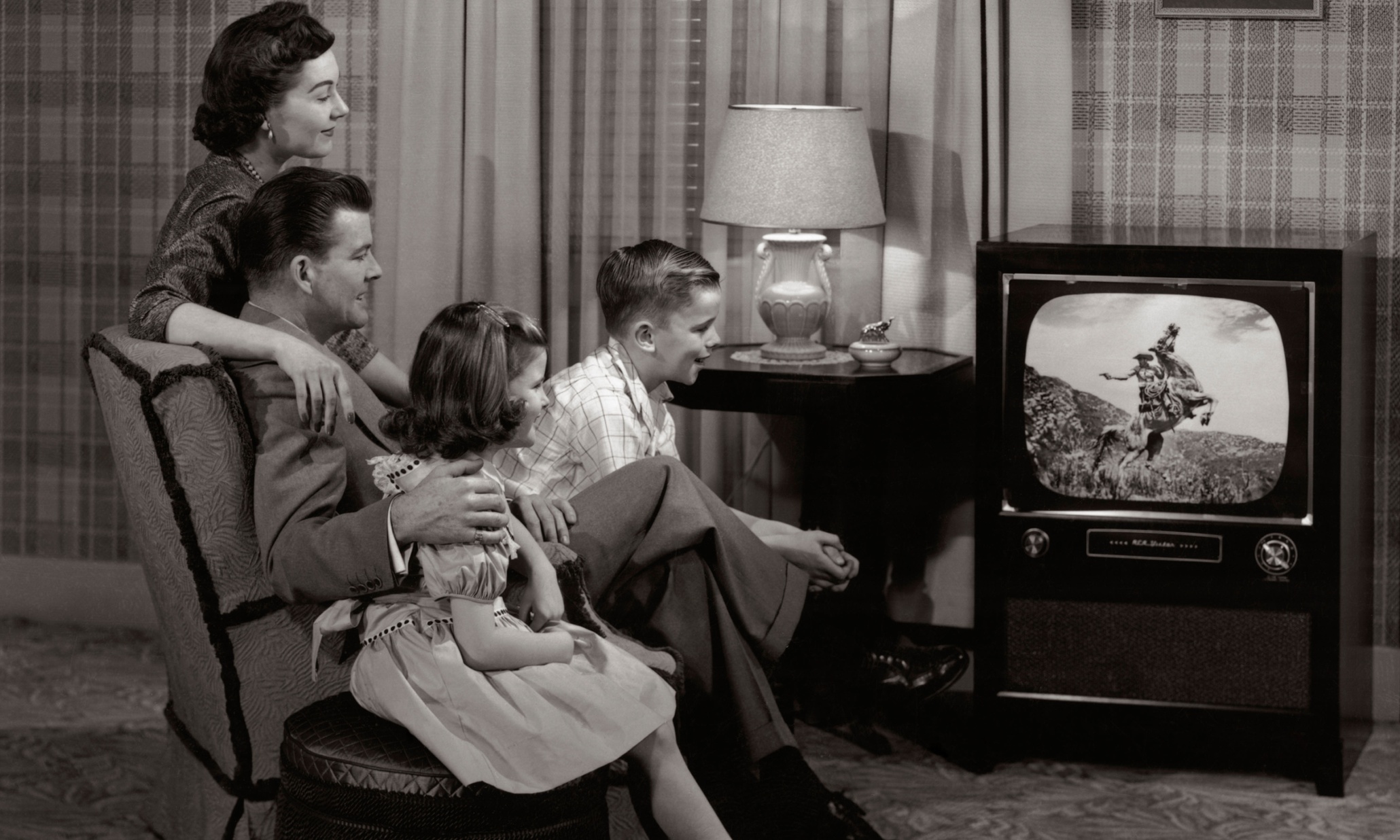 Family watching TV 1960's