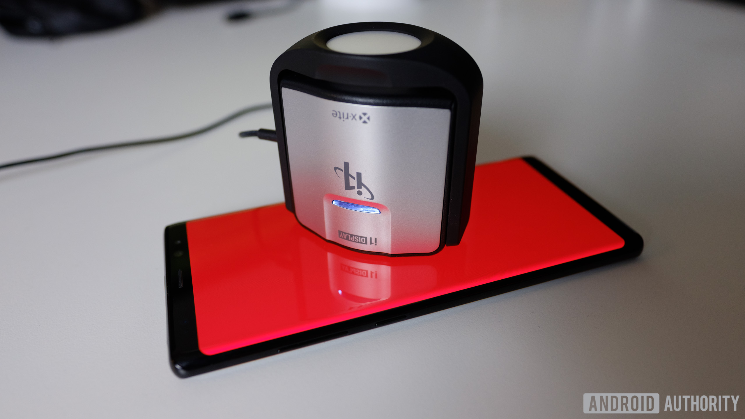 A photo of a smartphone being tested with a spectrophotometer.