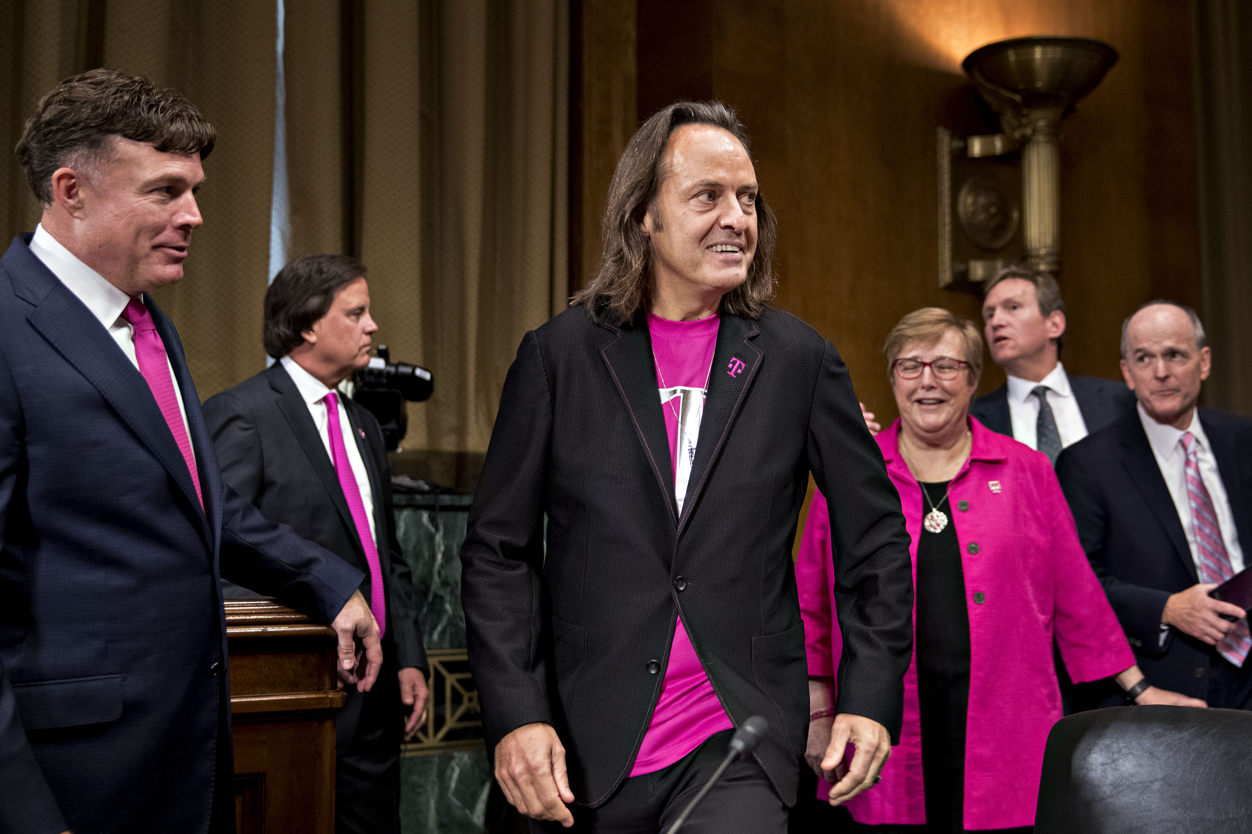 An image of John Legere and other T-Mobile employees at the Senate Judiciary Subcommittee meeting on June 28, 2018.