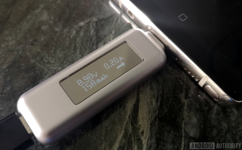 A charging dongle shows the amount of current passing to a fully charged smartphone