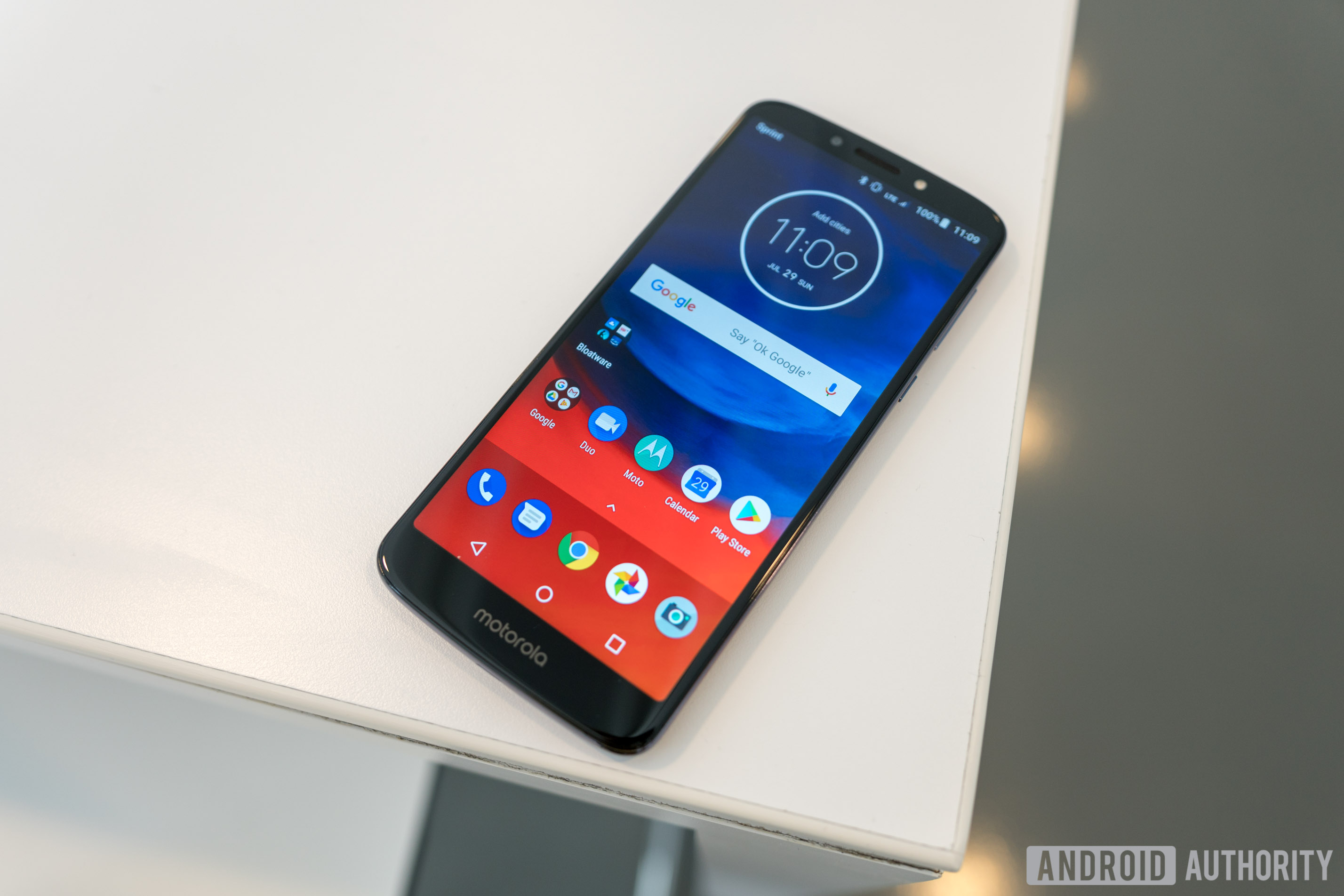 Motorola Moto E5 Plus laying on a table and showing its home screen, Moto E5 Plus review