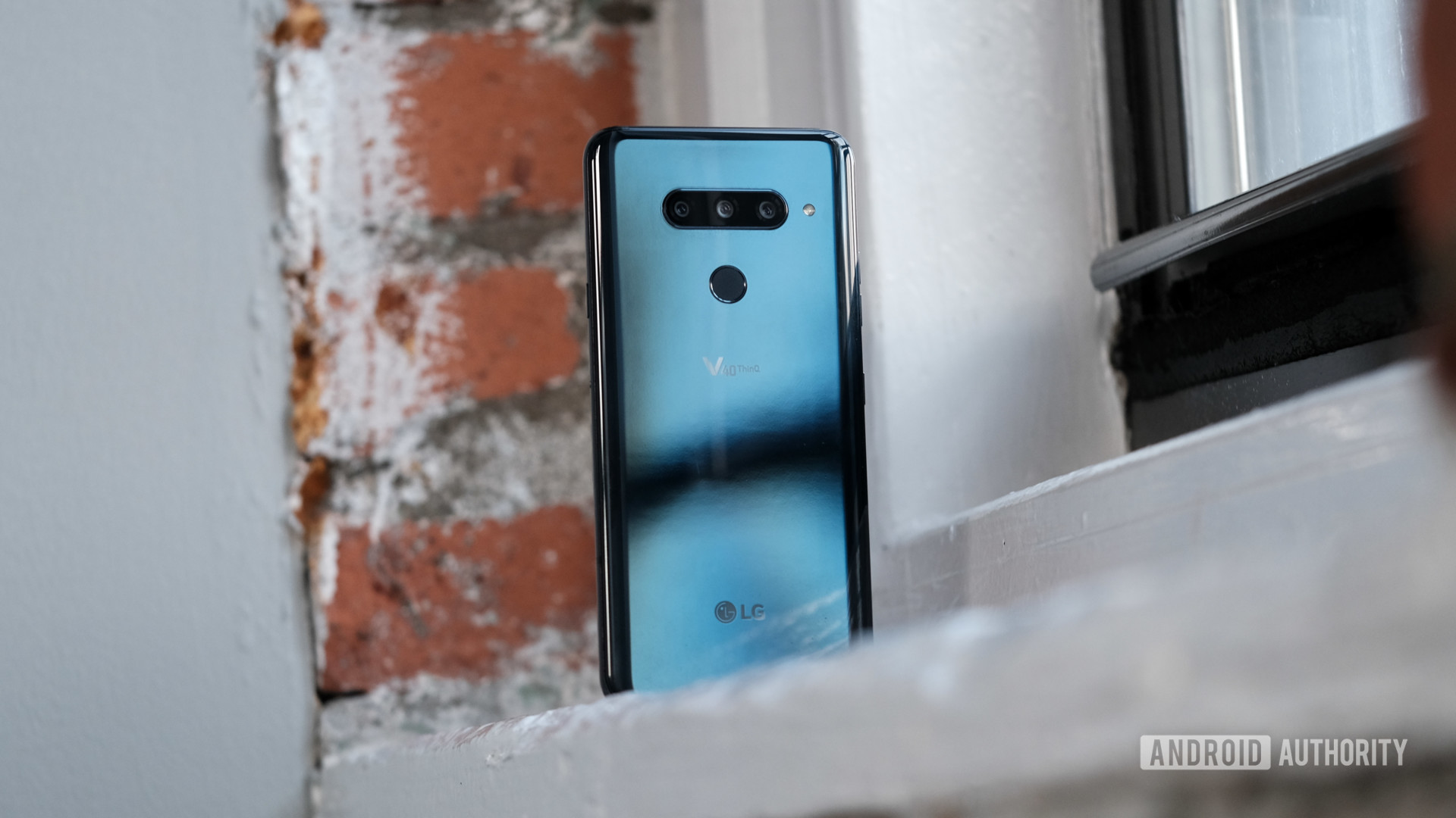LG V40 ThinQ sitting on a window sill showing back of phone