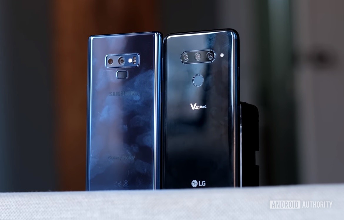 The LG V40 ThinQ and the Samsung Galaxy Note 9 standing next to each other on a shelf.