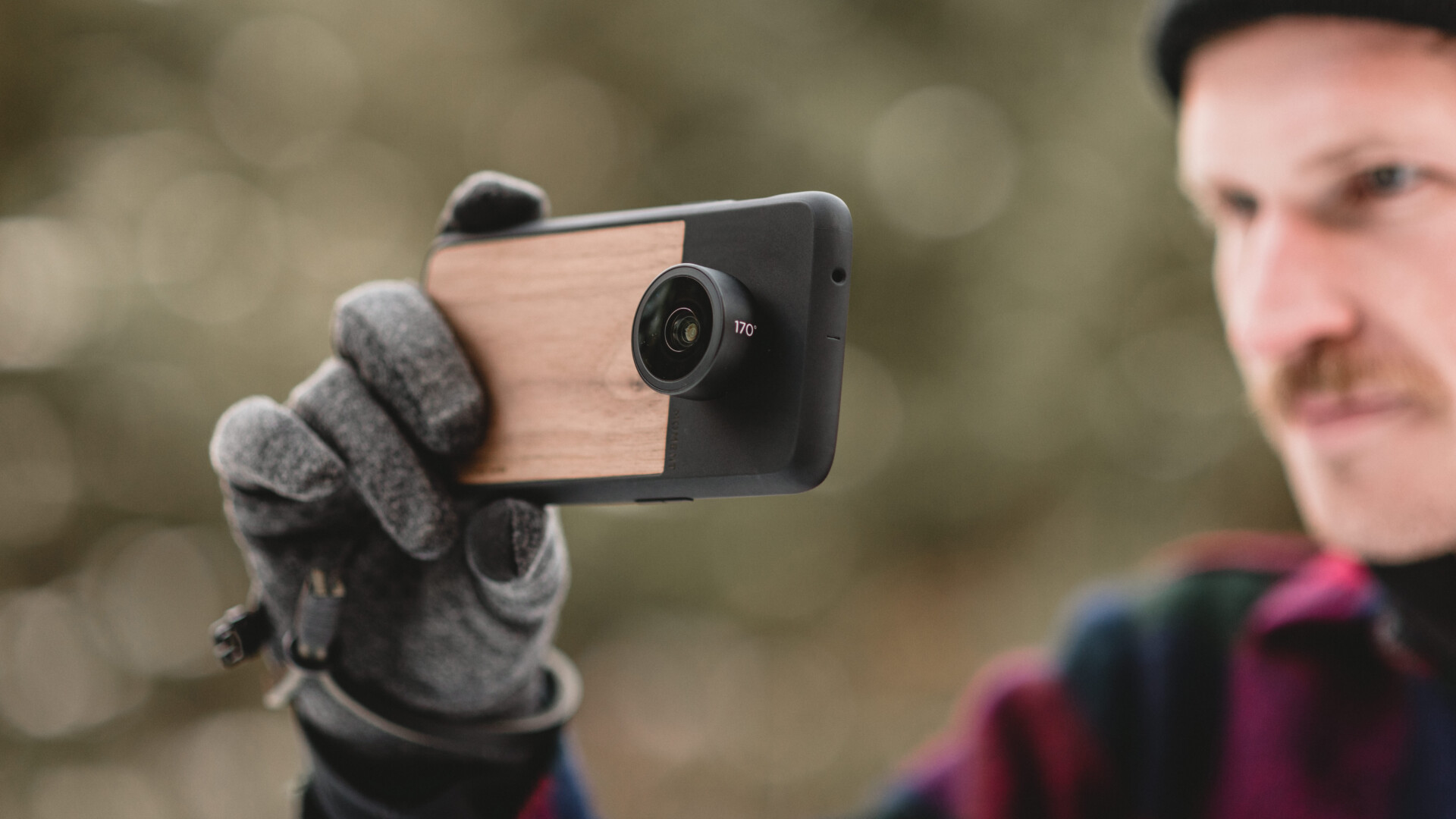 A promotional image of the OnePlus 6 with a Moment lens and camera case.
