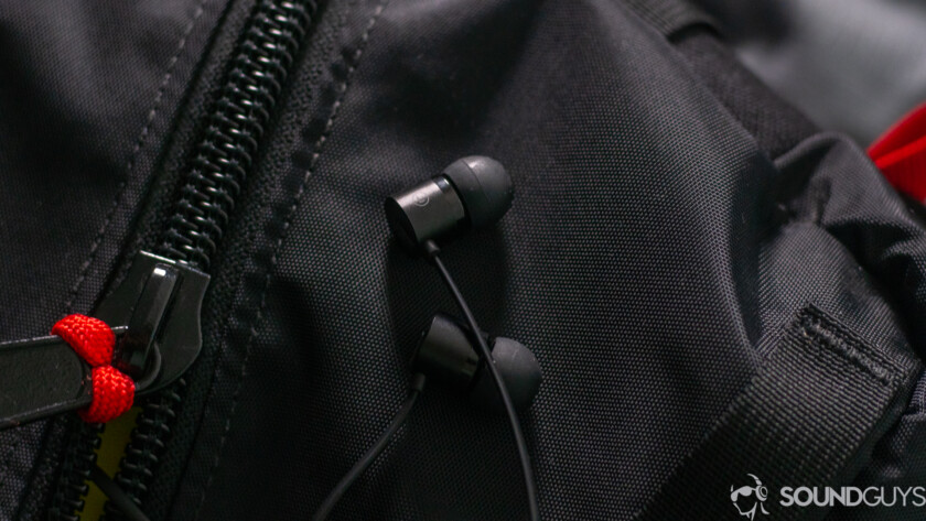 OnePlus Bullets USB-C headphones earbuds on black backpack. 