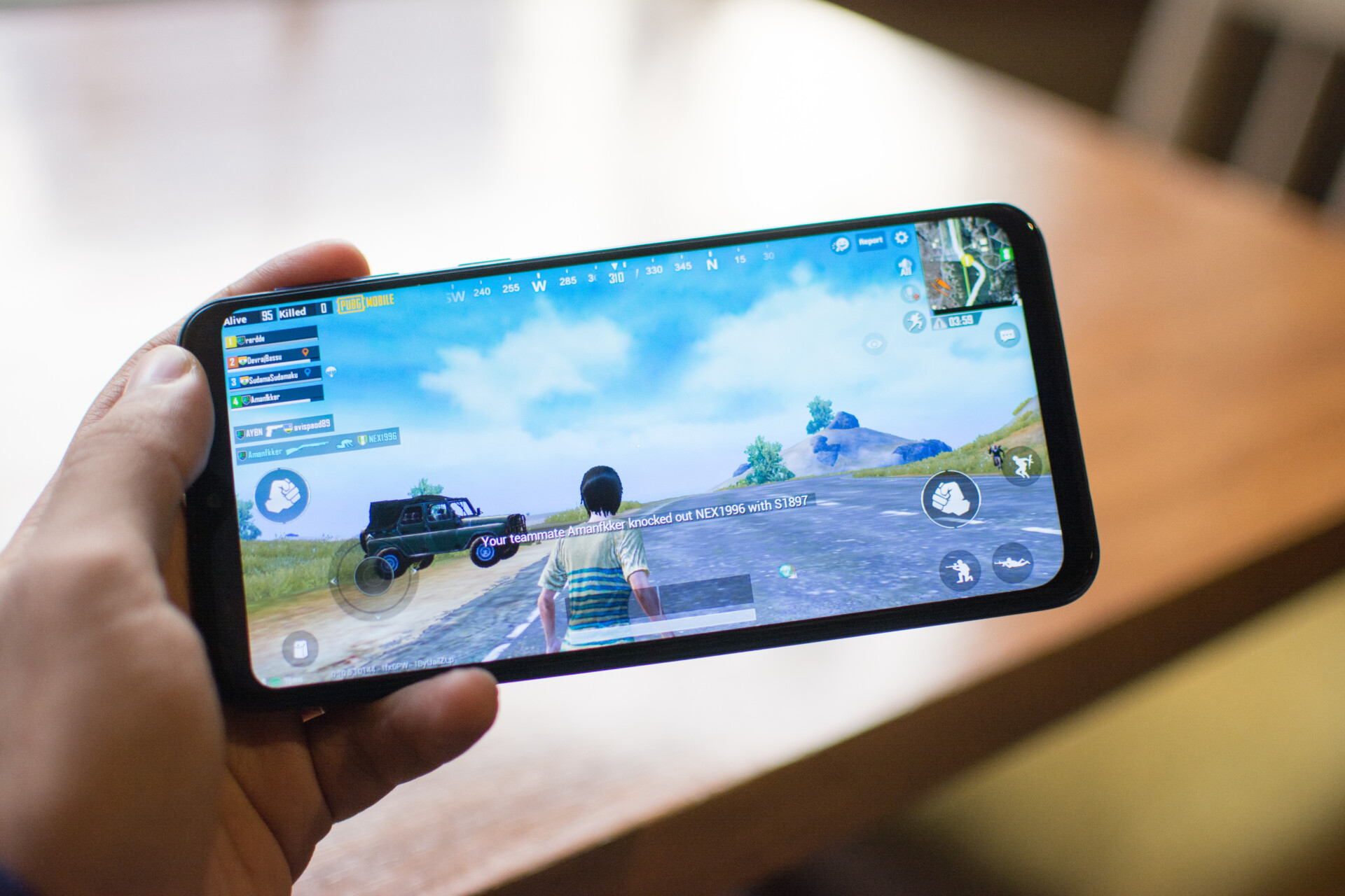 Samsung Galaxy M20 held in hand and playing PubG Mobile.