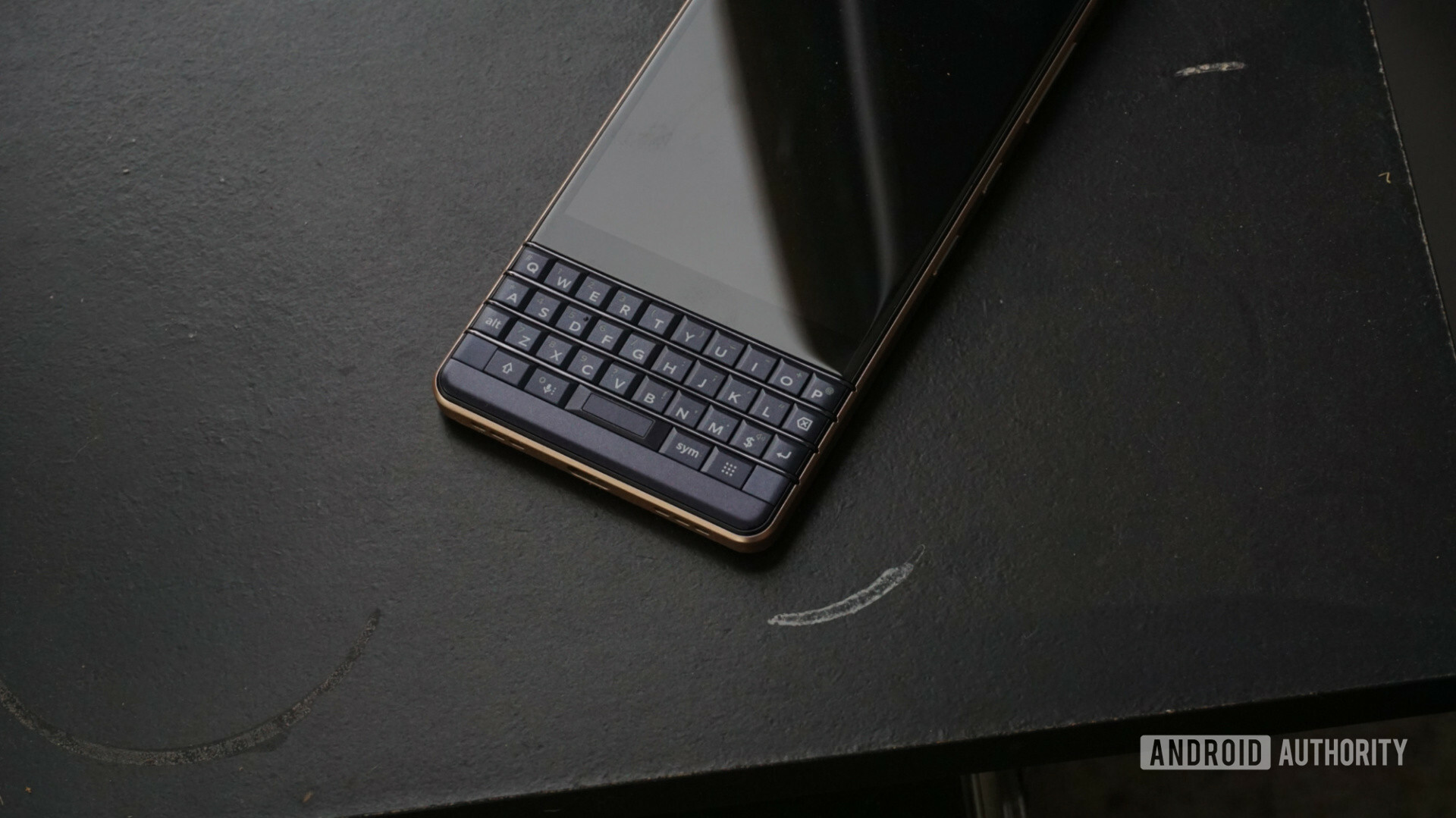 Front side of the new BlackBerry Key2 LE on a black surface.