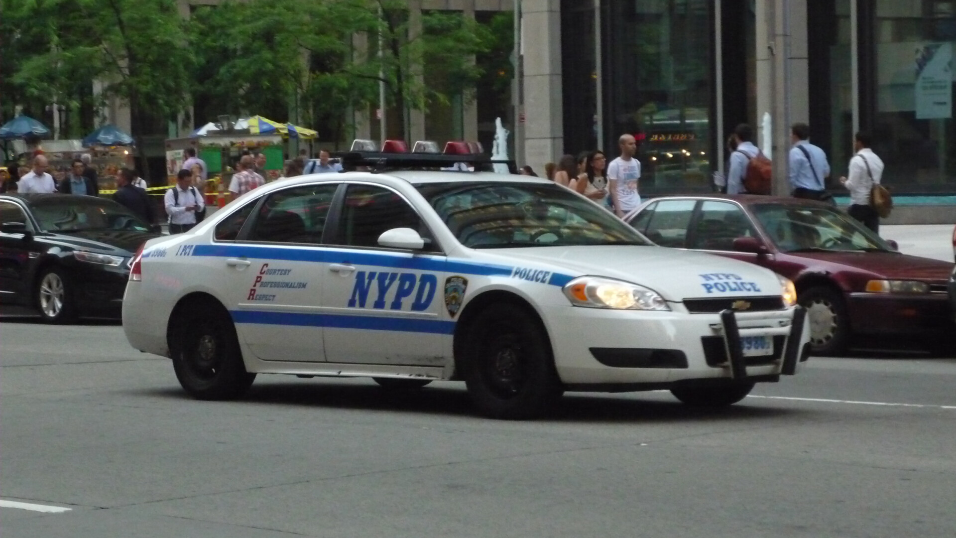 A NYPD patrol car parked on a city street.