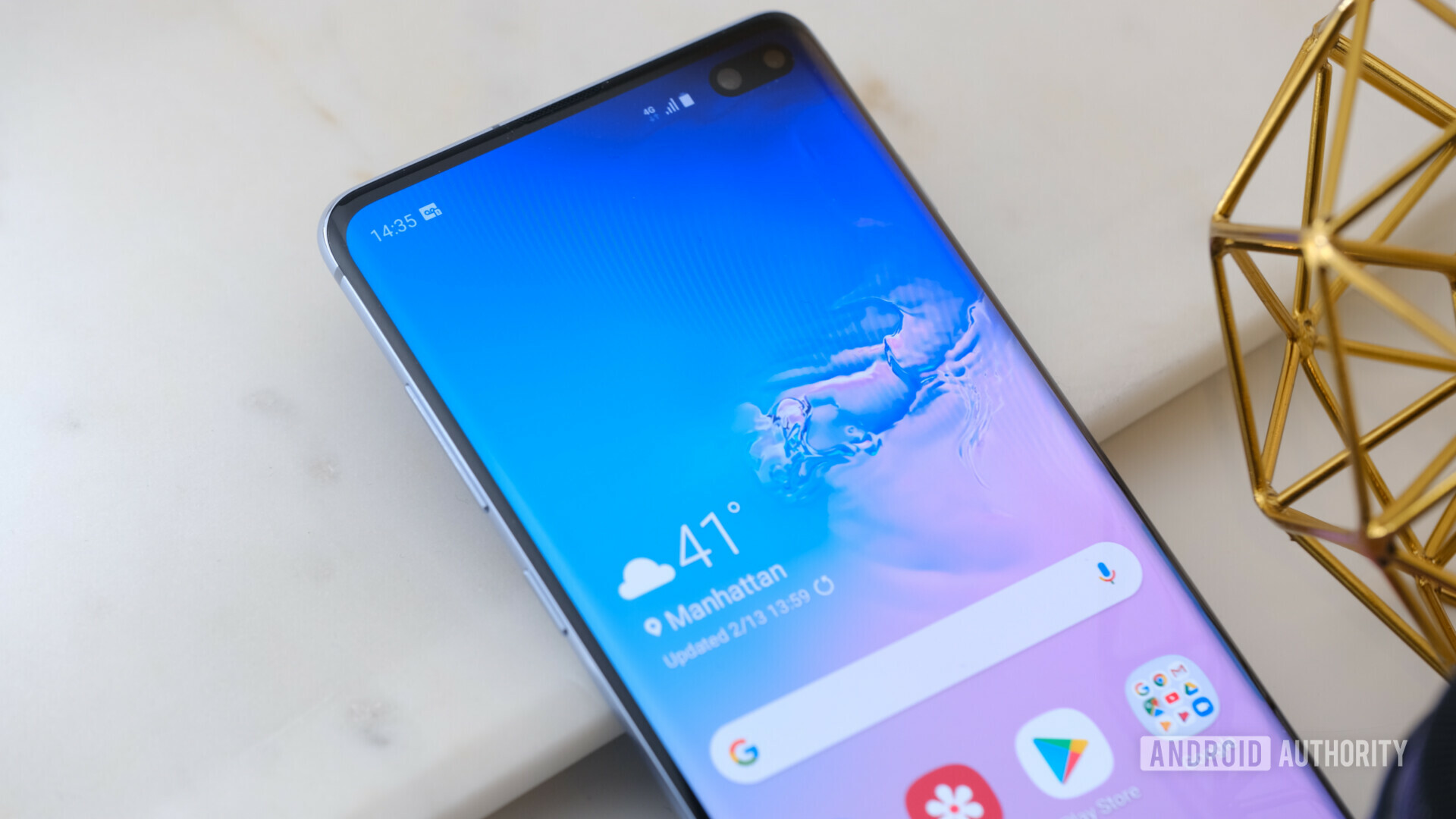 Front side of the Samsung Galaxy S10 Plus showing the default home screen.