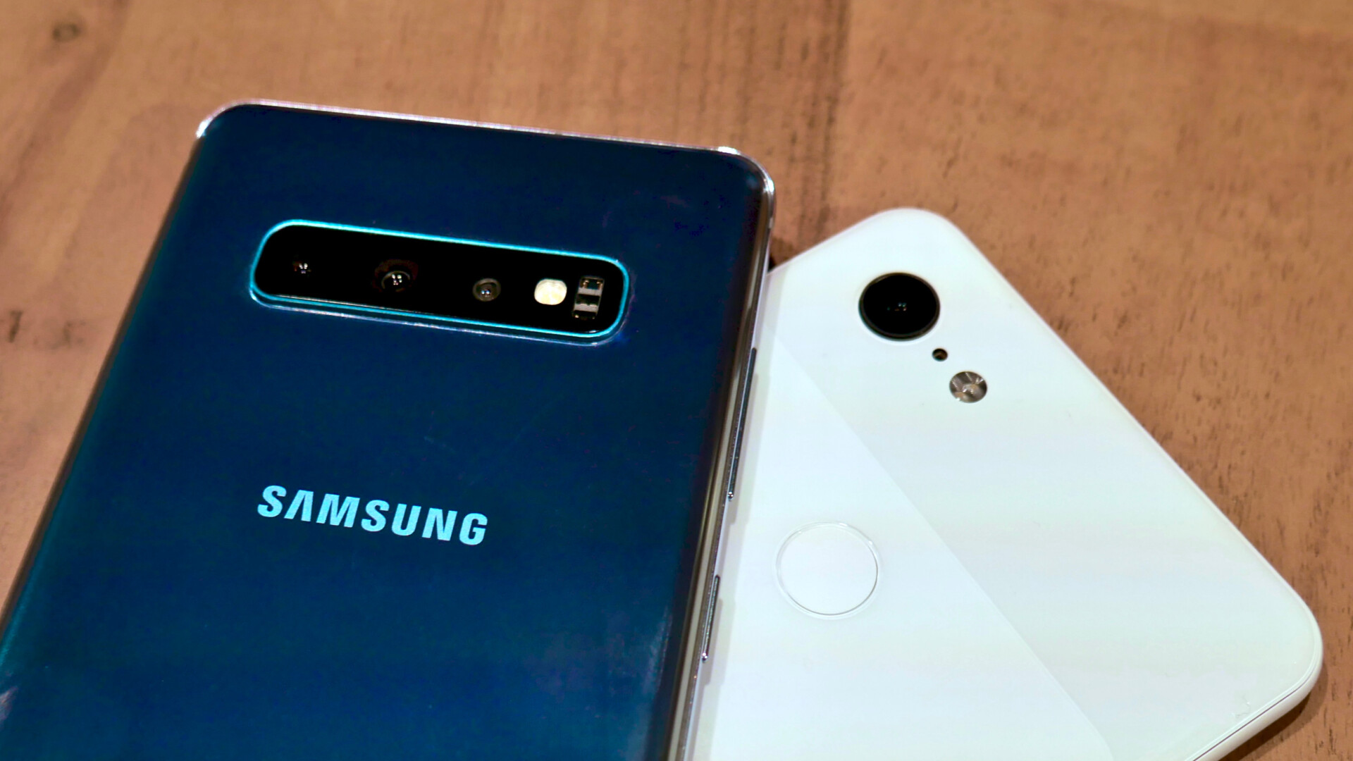 Photo of the backside of the Samsung Galaxy S10 Plus next to a Google Pixel 3 XL displaying the cameras