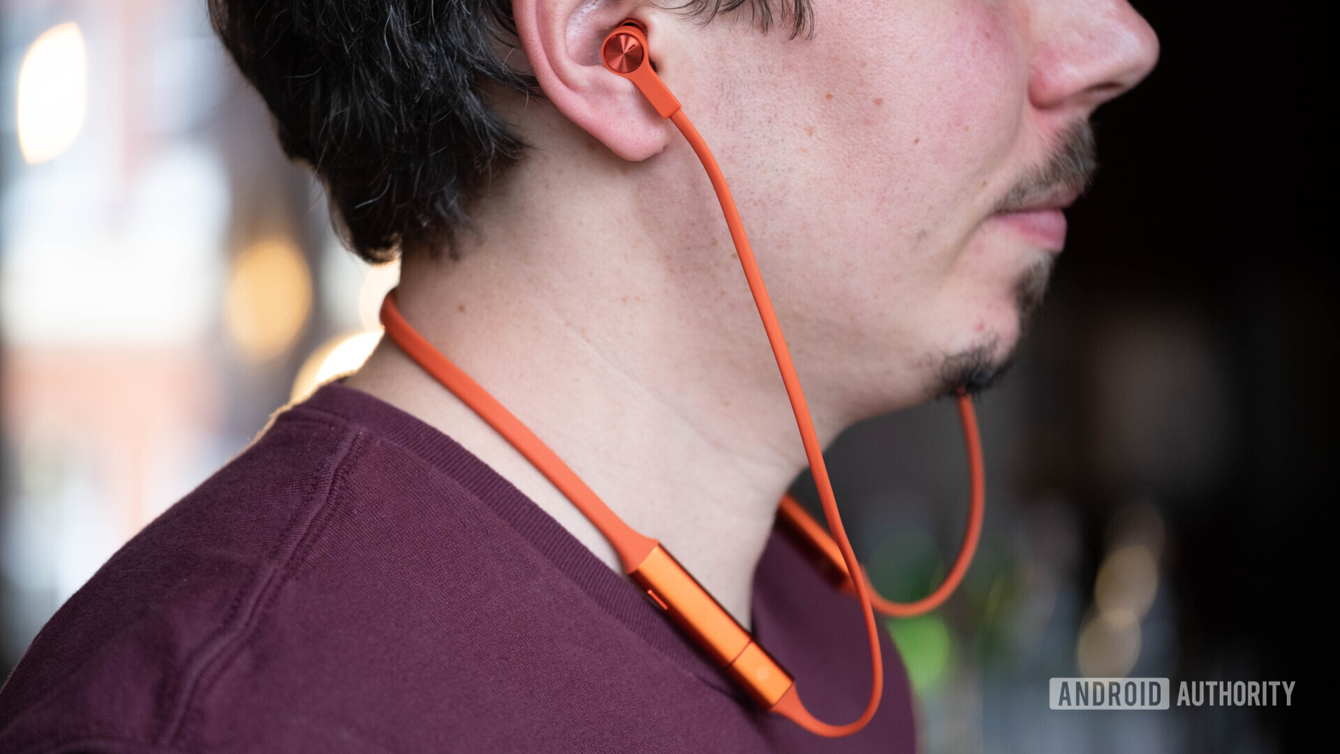 Profile of a man wearing the Huawei Freelace earbuds.