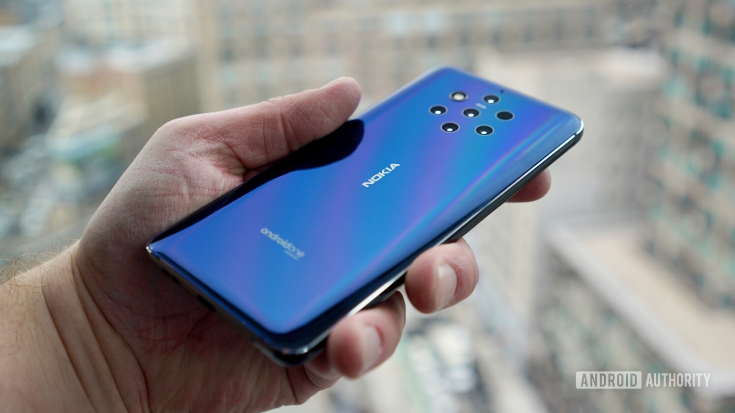The Nokia 9 PureView smartphone held in a person's hand showing off the back of the device.