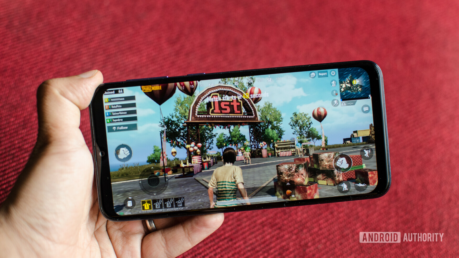 Front side of the Samsung Galaxy M30 held in hand and running PUBG game