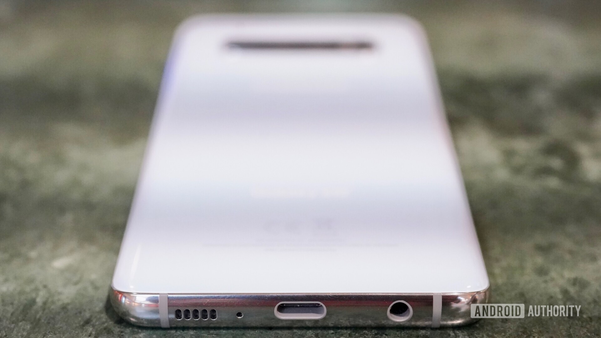 Photo of the Samsung Galaxy S10 focusing on the USB Type-C and headphone jack.