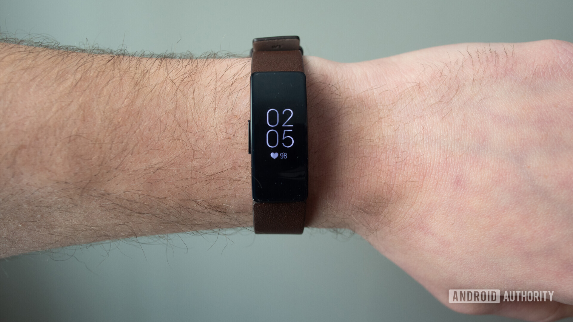 fitbit inspire hr display brown leather strap on wrist