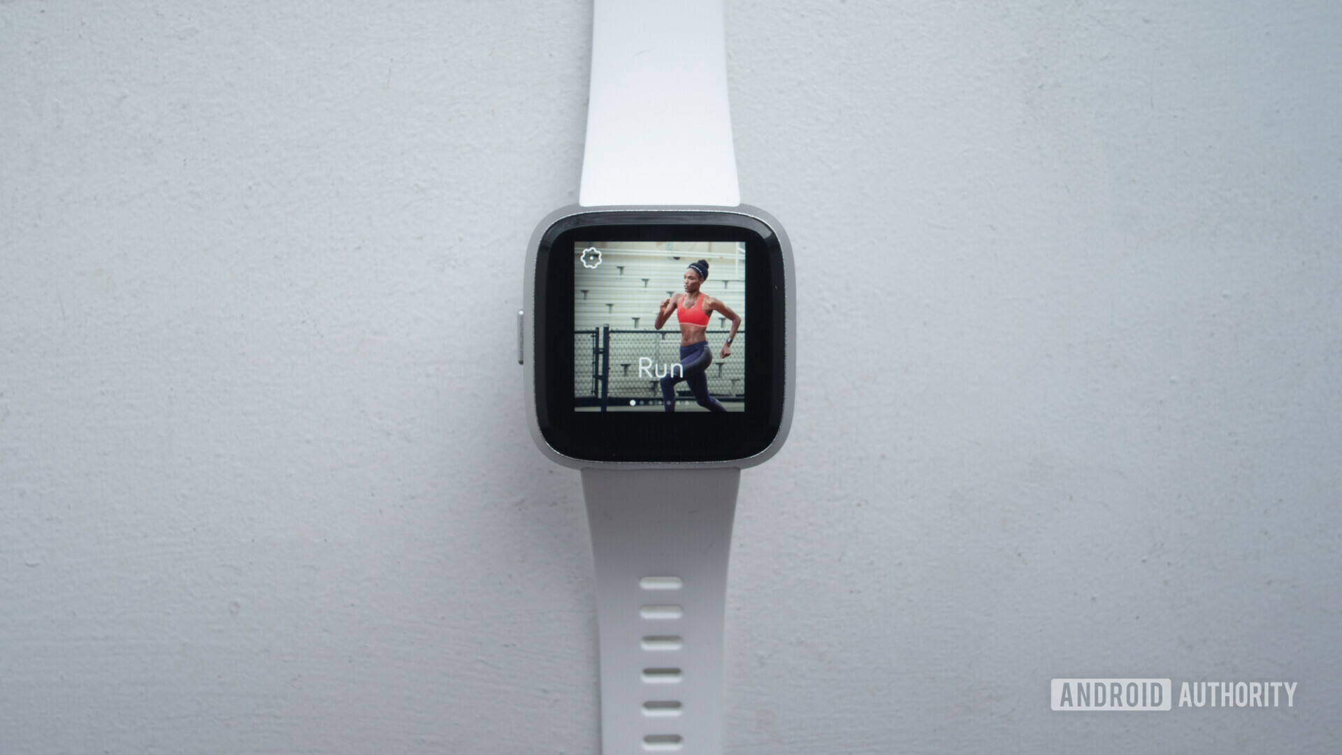 Frontside of the Fitbit Versa Lite on a white background showing the Run menu.