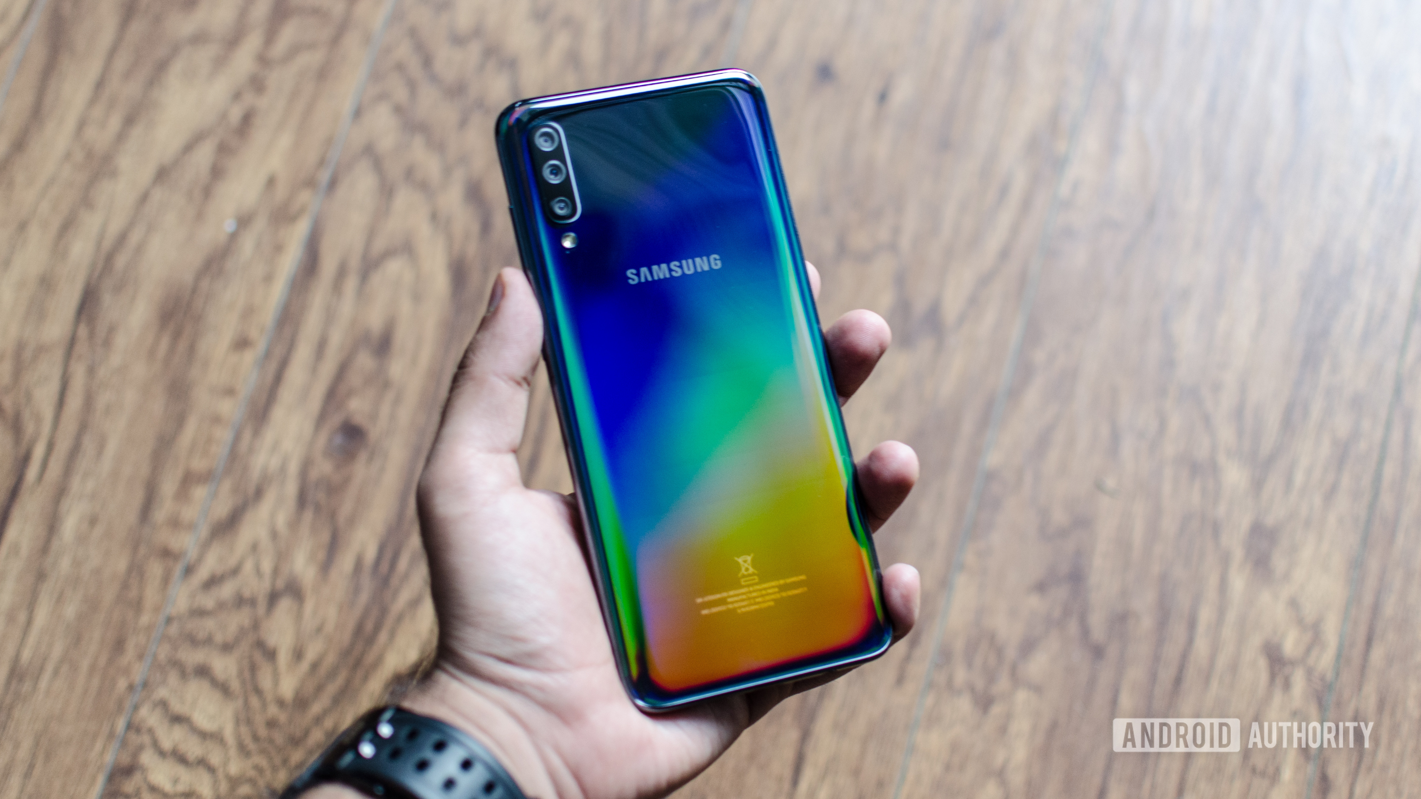 Samsung Galaxy A70 in hand showing back