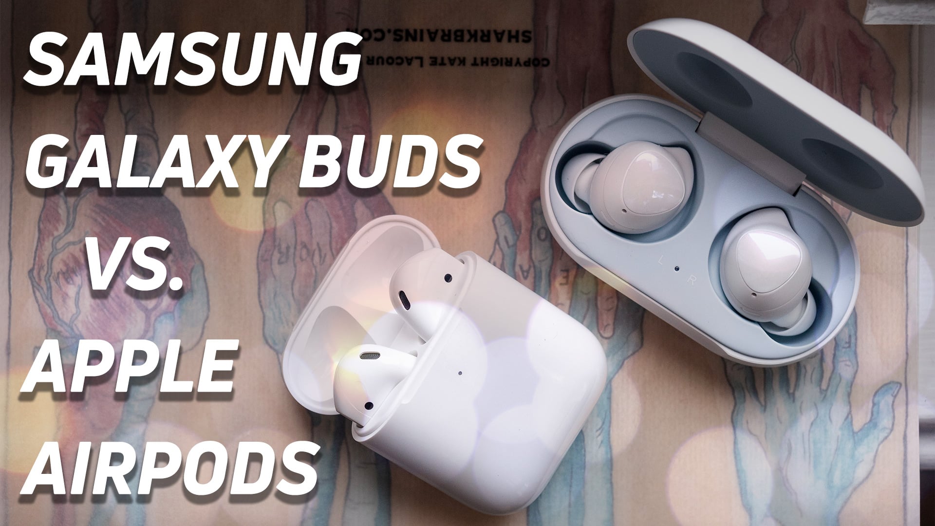 Samsung Galaxy Buds versus Apple's new AirPods (2019) top-down hero image.