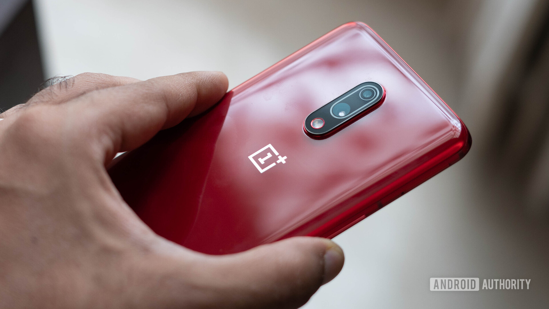 OnePlus 7 red in hand showing back