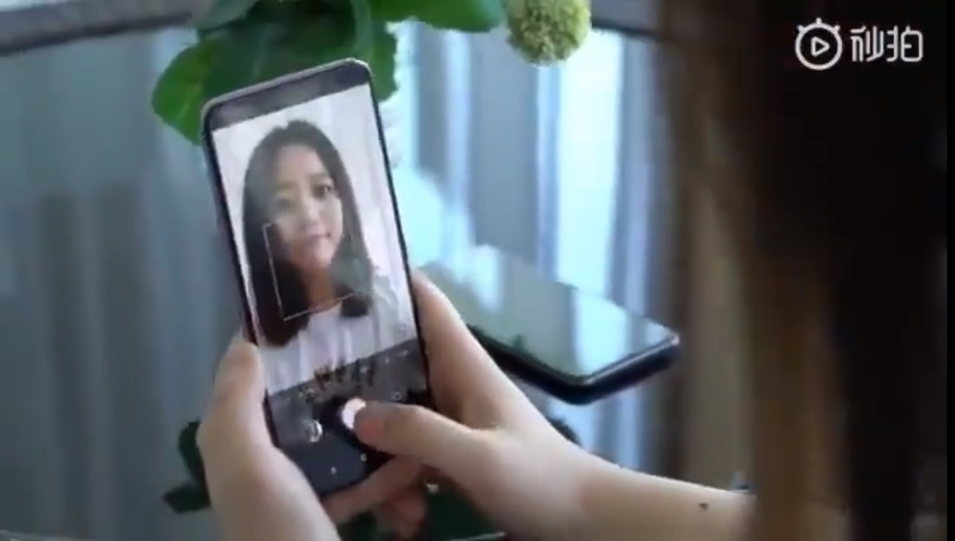 Xiaomi Mi 9 with under screen camera taking a selfie.