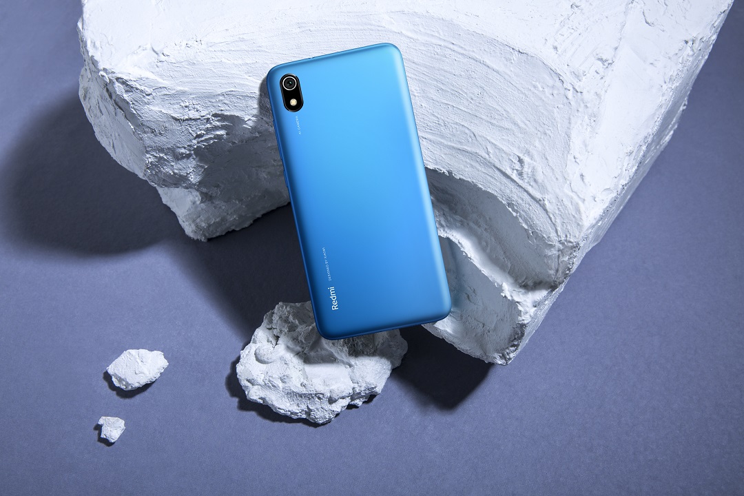 The Redmi 7A in blue on a white rock.