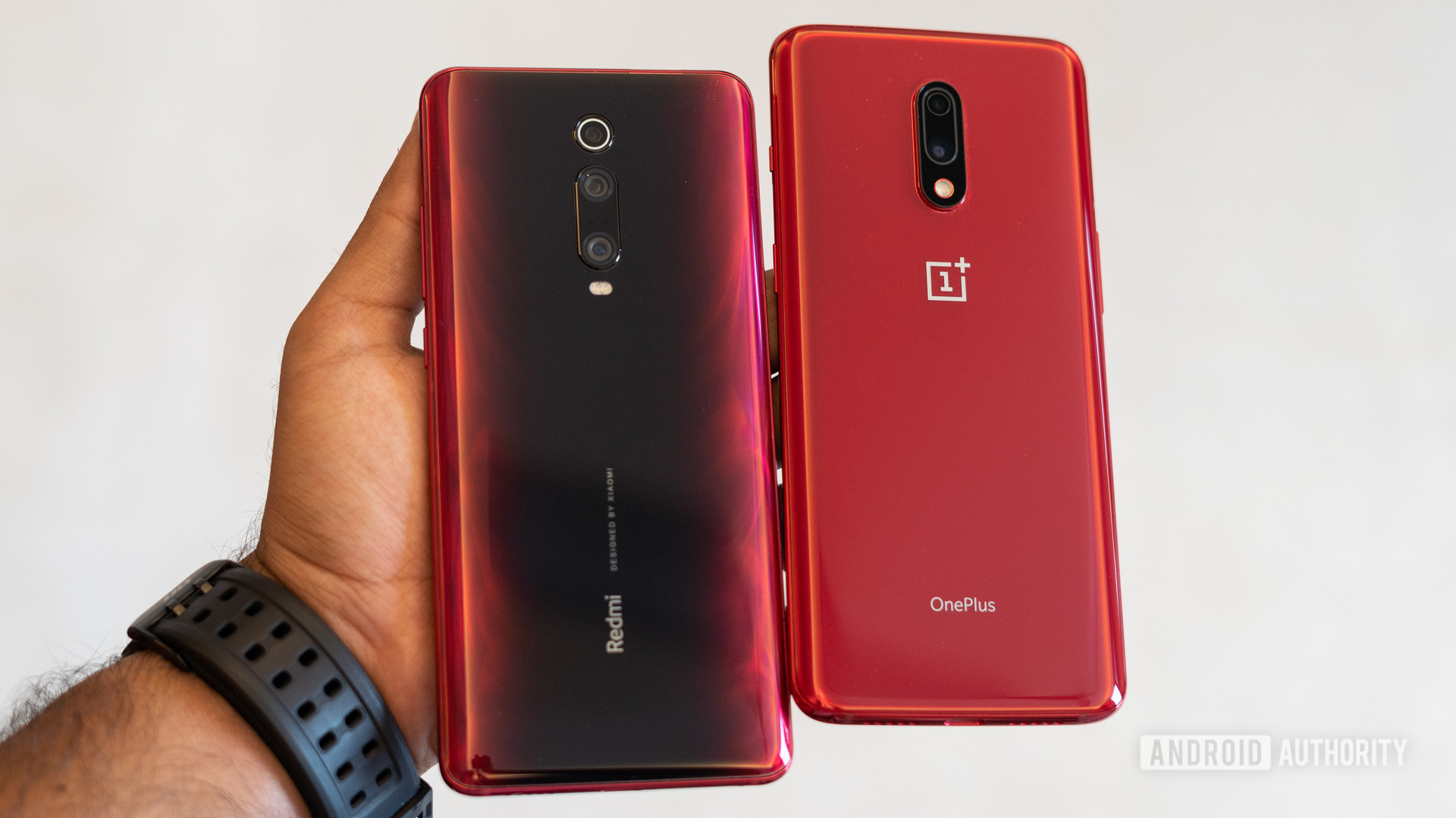 Redmi K20 Pro vs OnePlus 7 showing back of the phones in hand