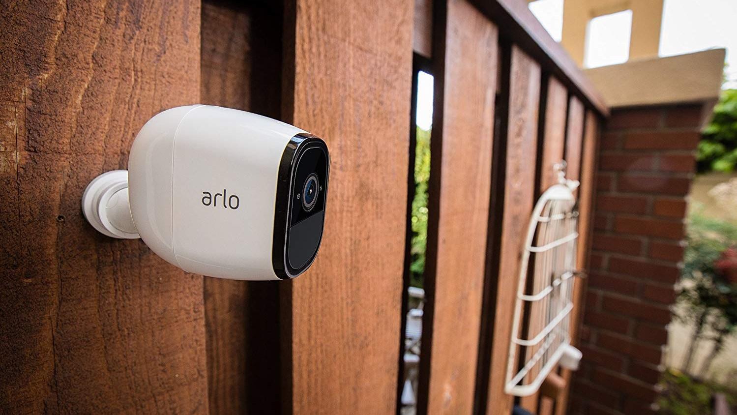 The Arlo Pro information    camera attached to a wall.