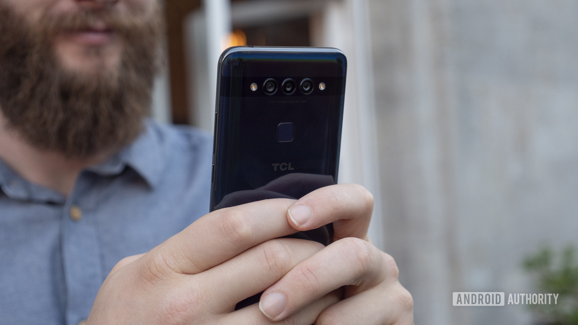 TCL Plex hands on blue in hand rear cameras 6