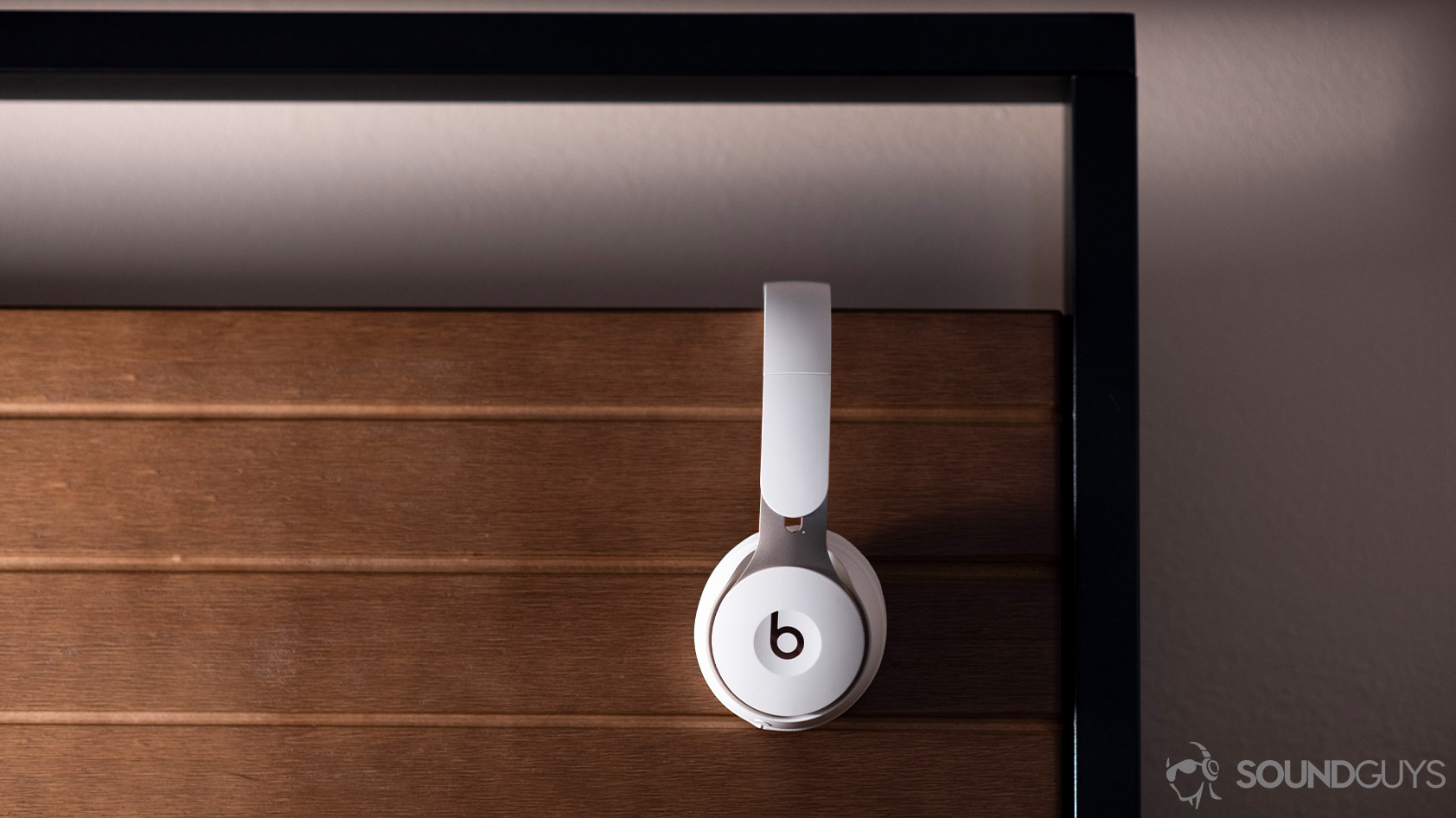 Beats Solo Pro noise cancelling headphones profile wood background
