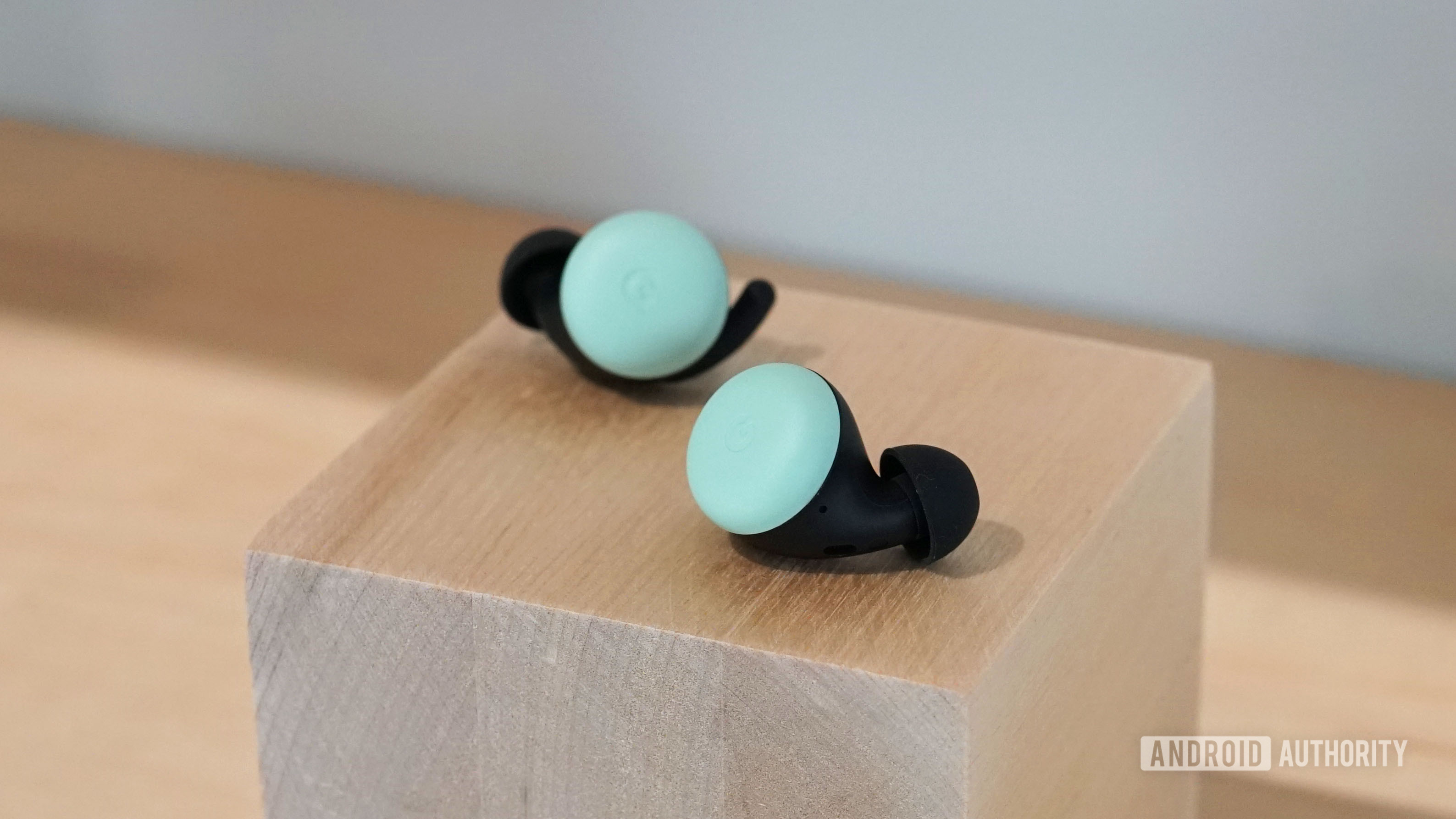 Google Pixel Buds 2 in Quite Mint on a wooden block