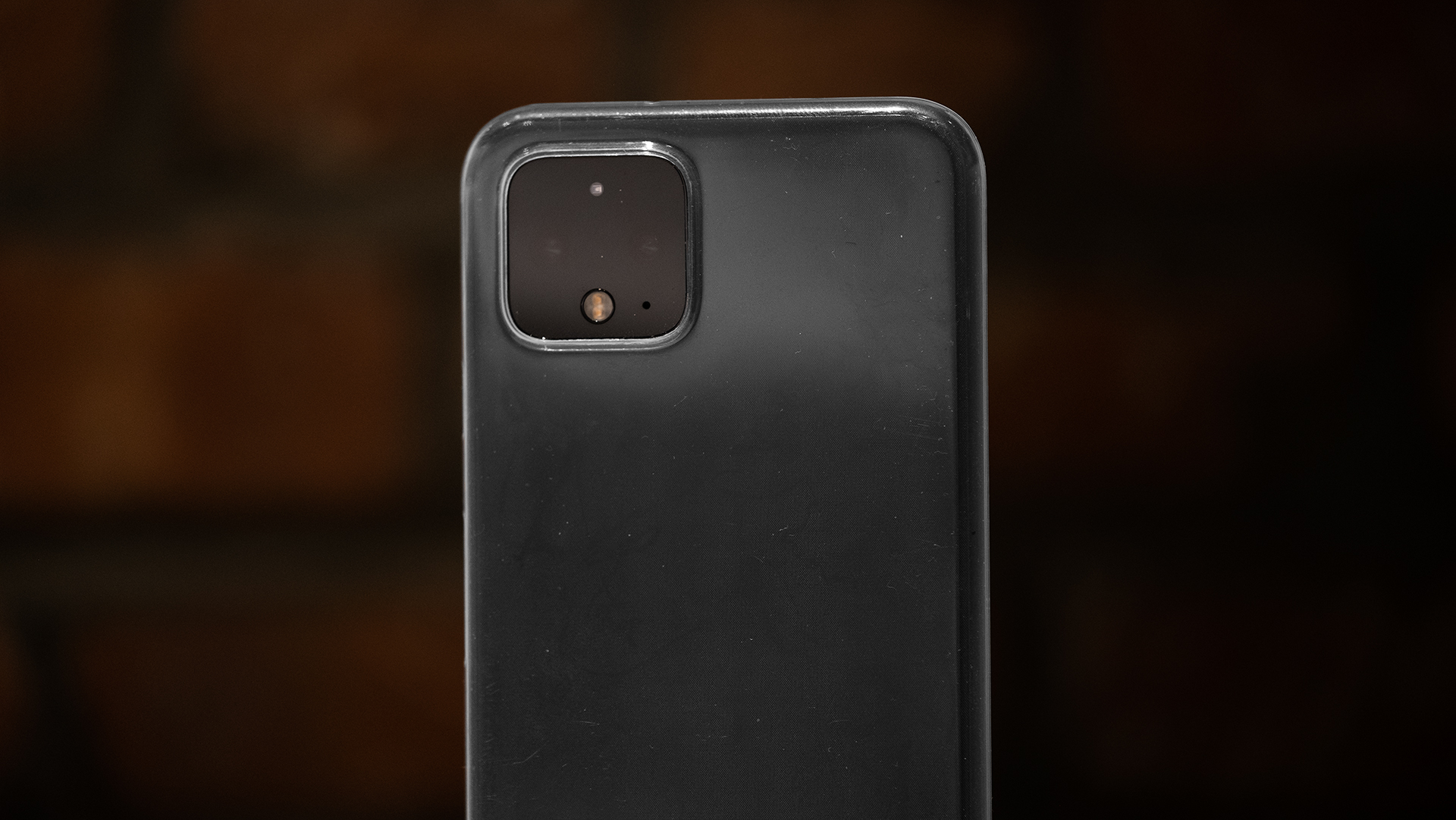 Pixel 4 in clear MNML case standing upright against brick