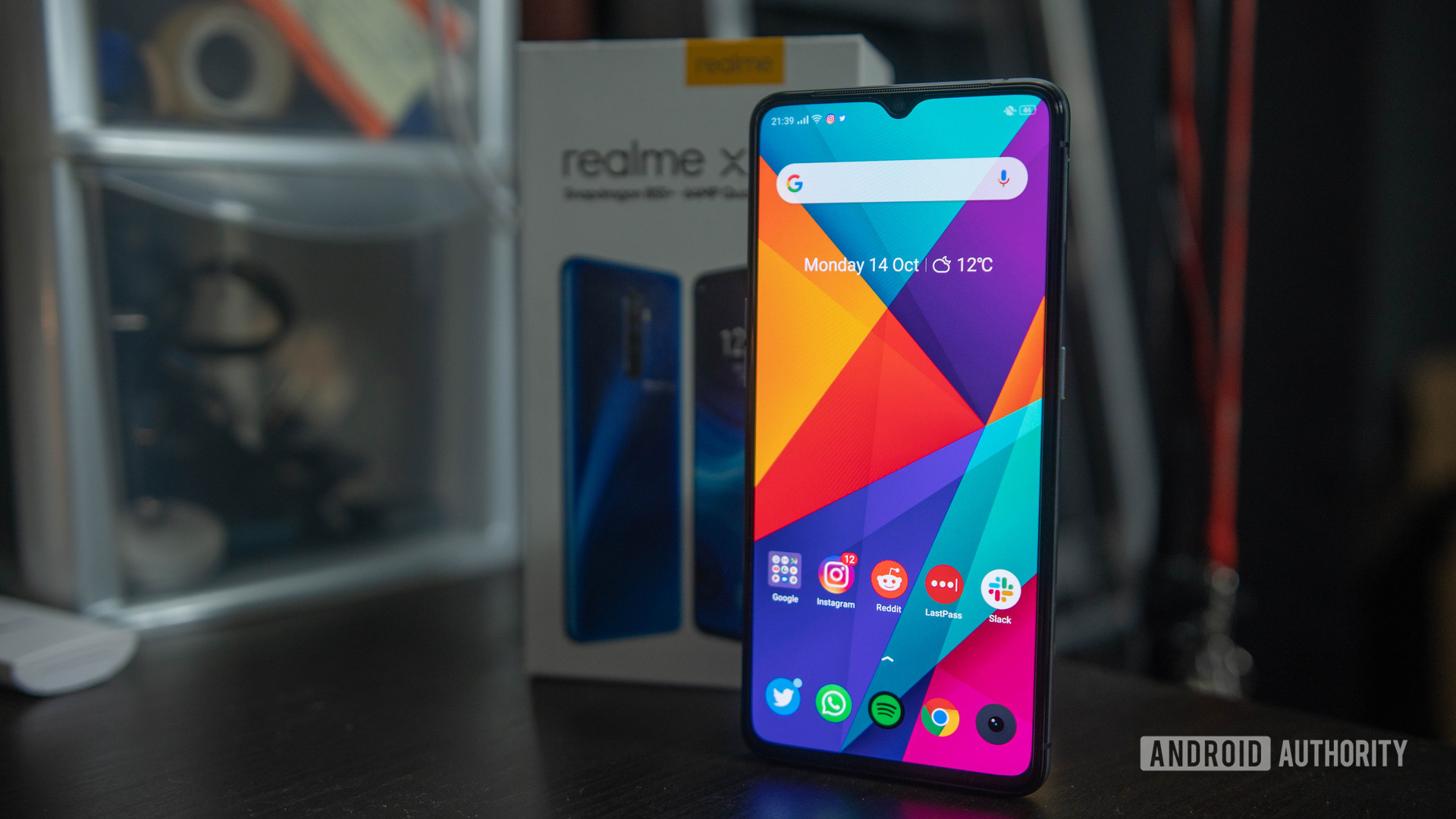 Realme X2 Pro screen on in front of box wide