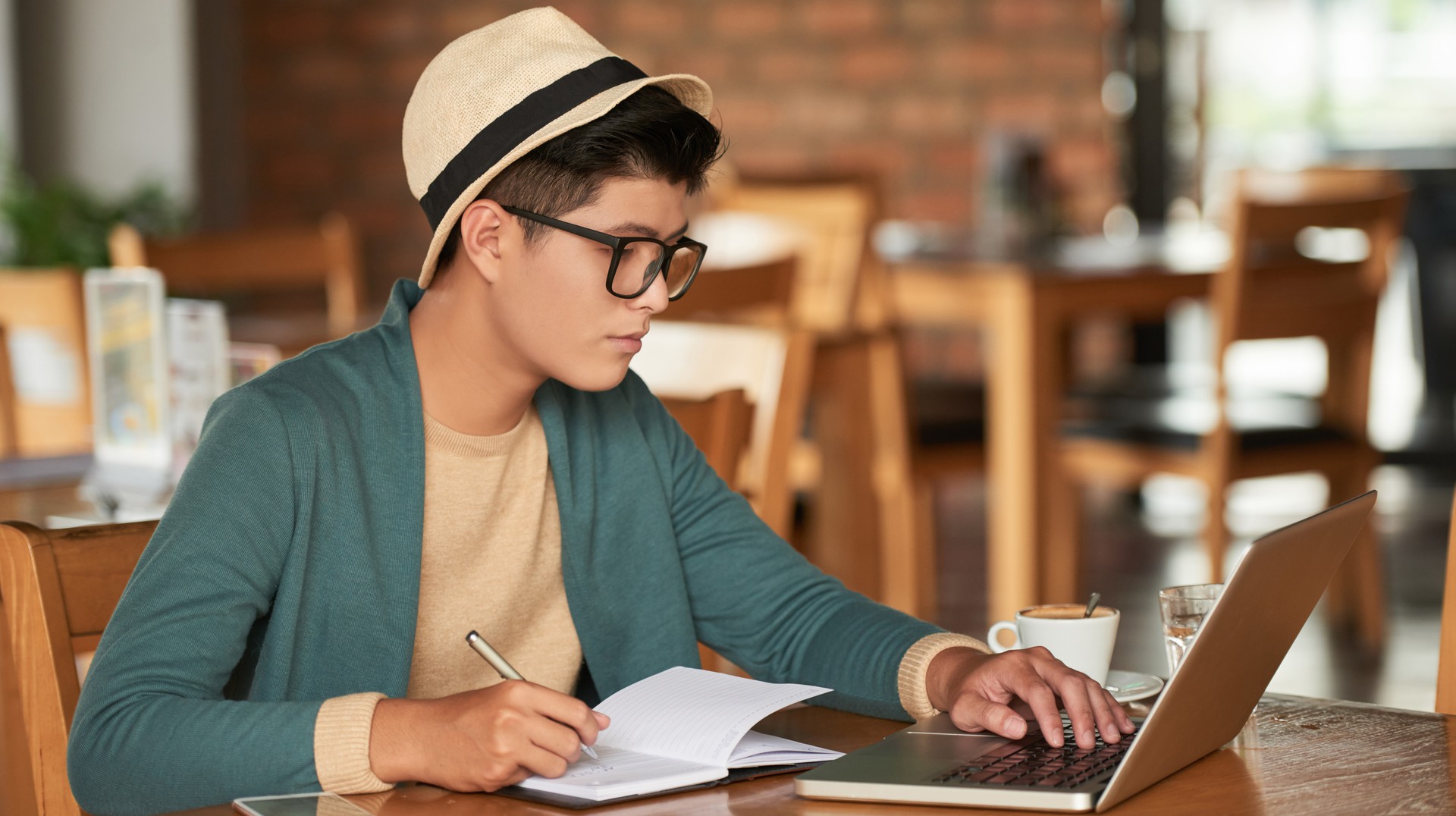 man studying in cafe on laptop
