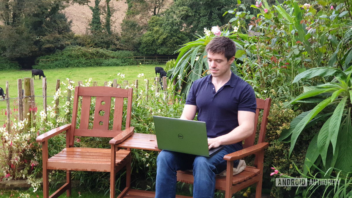 Man in garden with tethered laptop