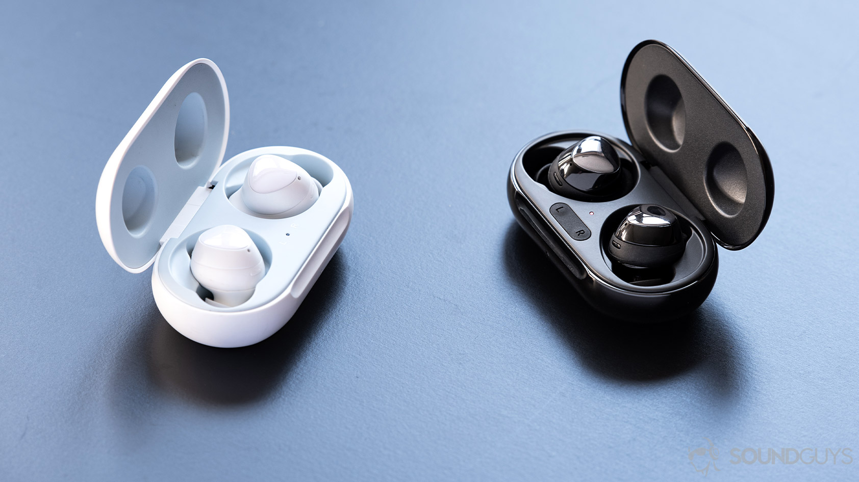 A picture of the Samsung Galaxy Buds Plus and Galaxy Buds side by side in a comparison with the charging cases open to reveal the respective true wireless earbuds.
