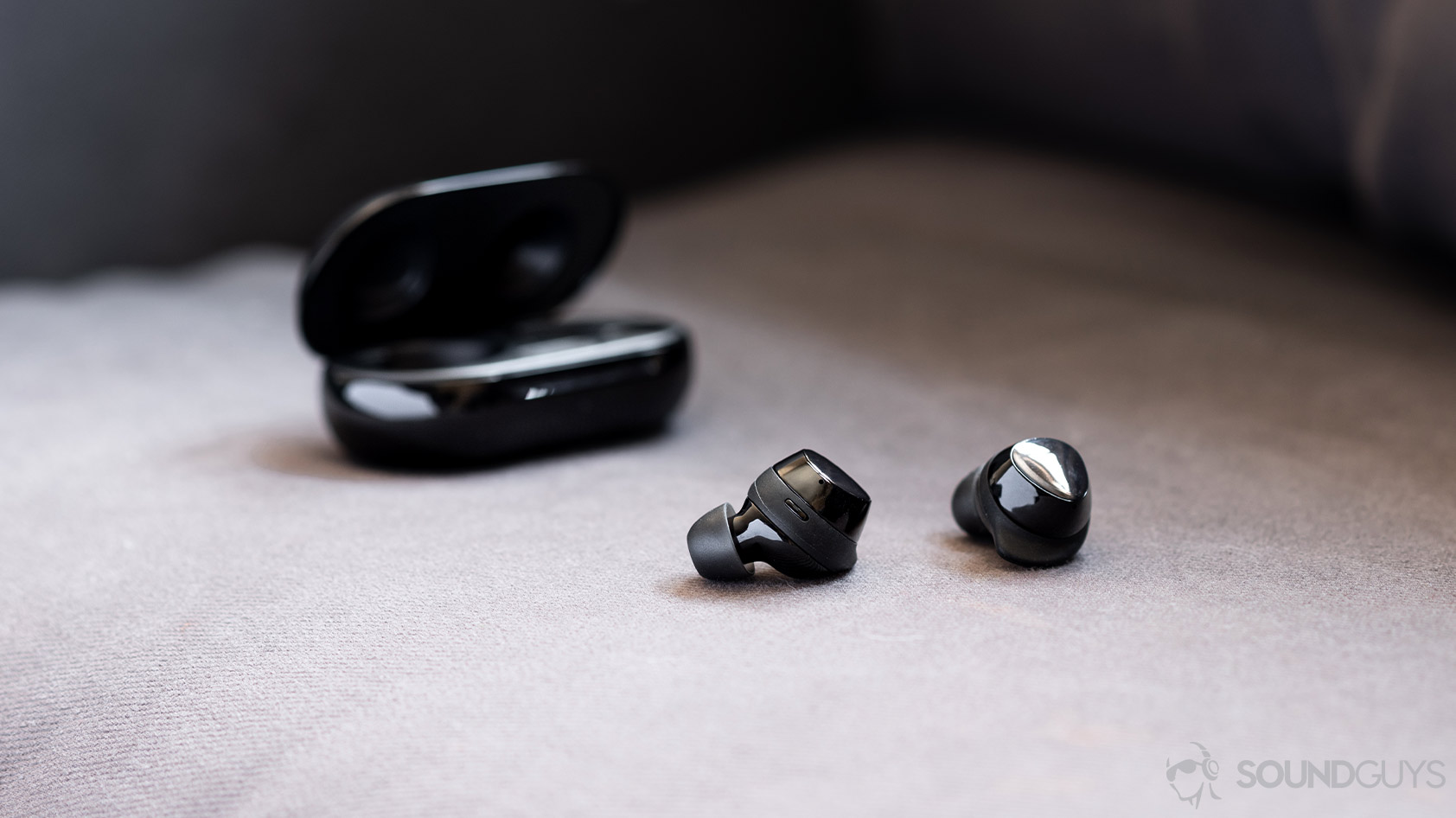 A picture of the Samsung Galaxy Buds Plus true wireless earbuds on a gray surface.