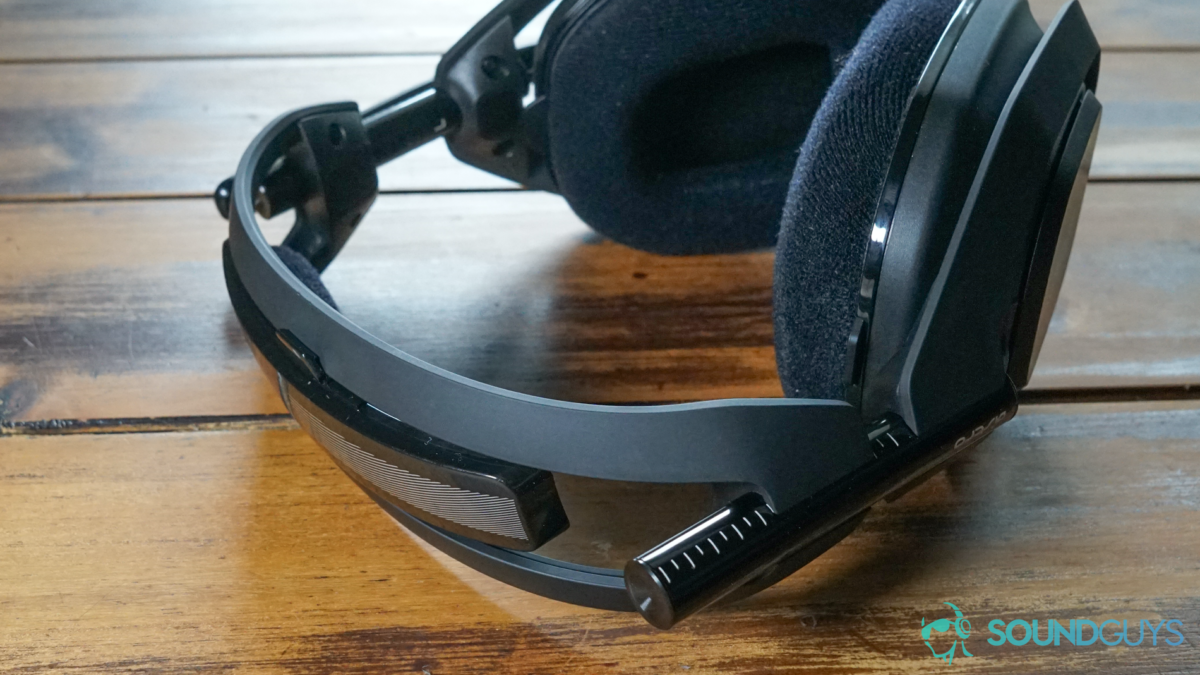 The Astro Gaming A50 Wireless sits on a wooden table, displaying the headband.