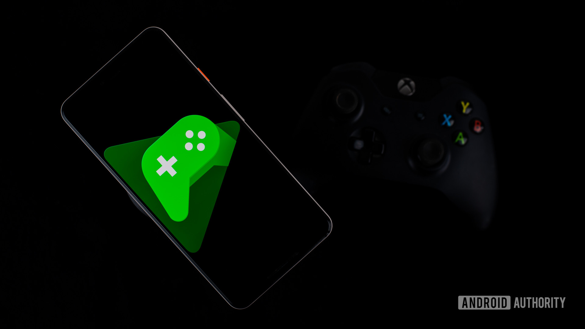 Google Play Games on smartphone next to controller