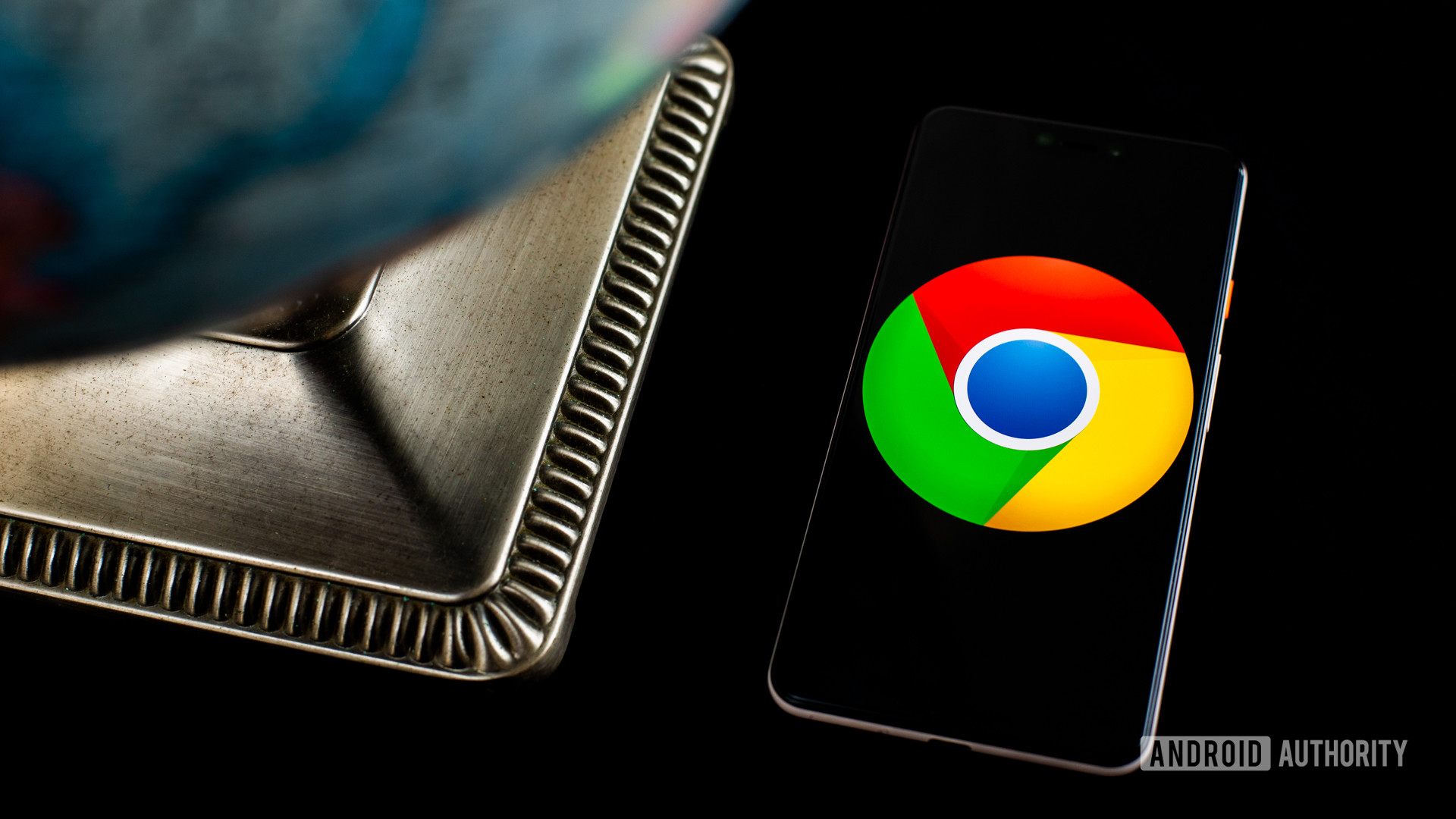 Chrome logo on smartphone next to globe