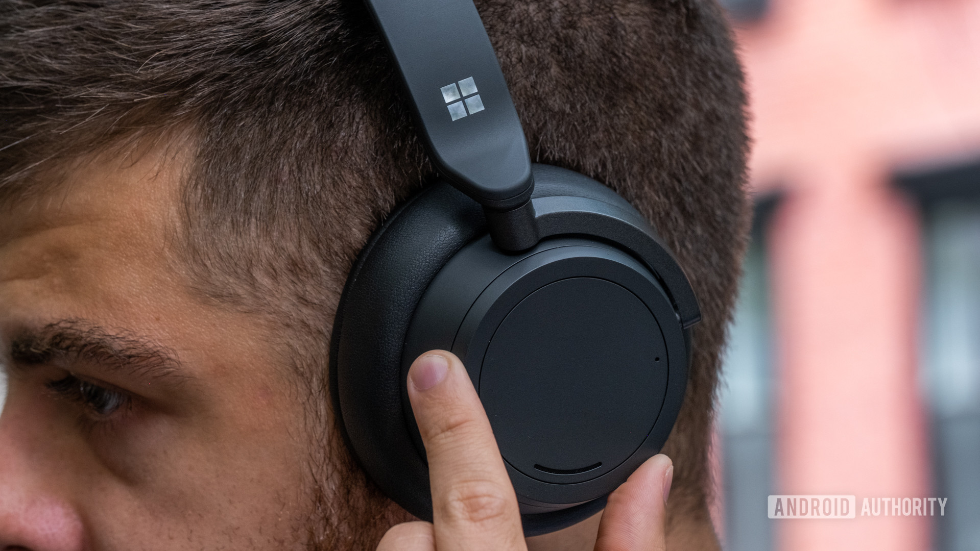 A picture of a man wearing the Microsoft Surface Headphones 2