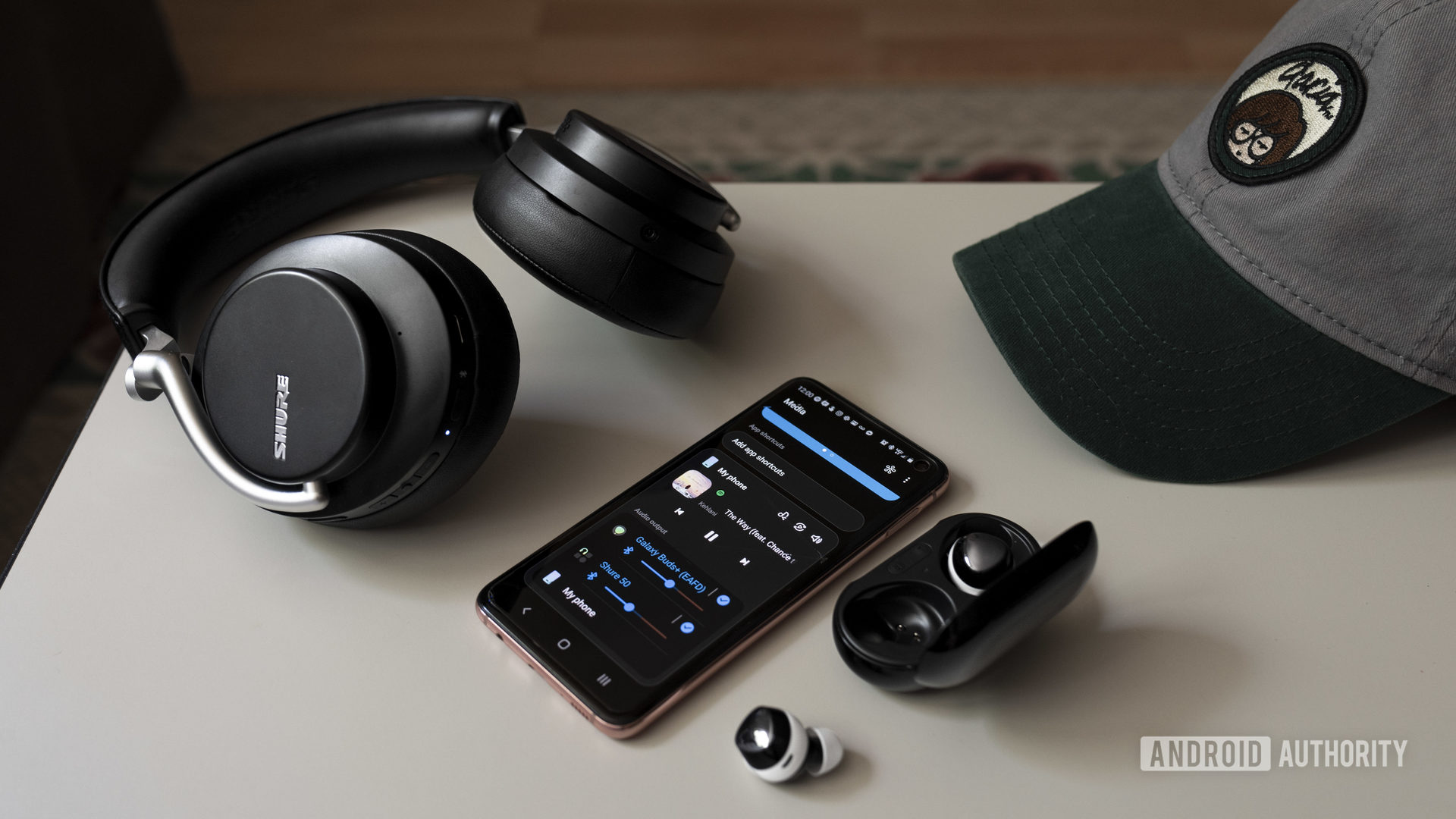 A photo of Samsung Dual Audio outputting from a Samsung Galaxy S10e smartphone to the Galaxy Buds Plus and Shure AOJNIC 50.