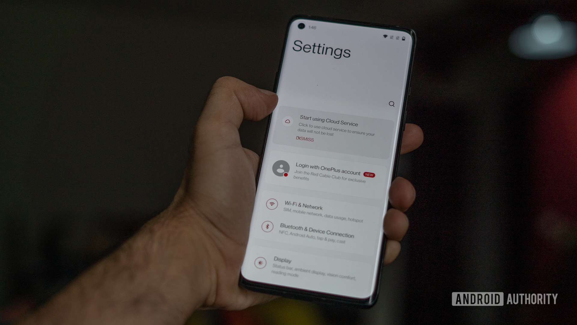 OnePlus Oxygen OS 11 Android 11 settings on phone screen in hand.