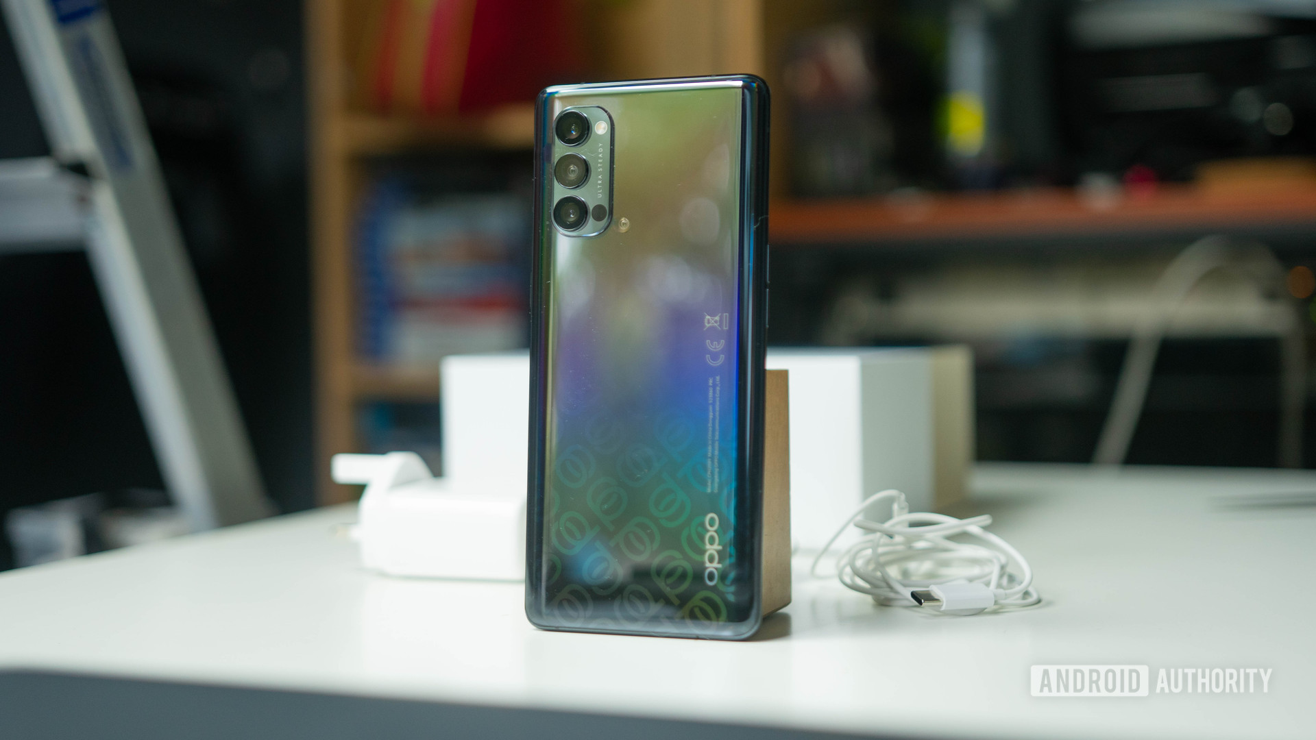 Oppo Reno 4 Pro 5G rear shot on a desk next to the charger and box