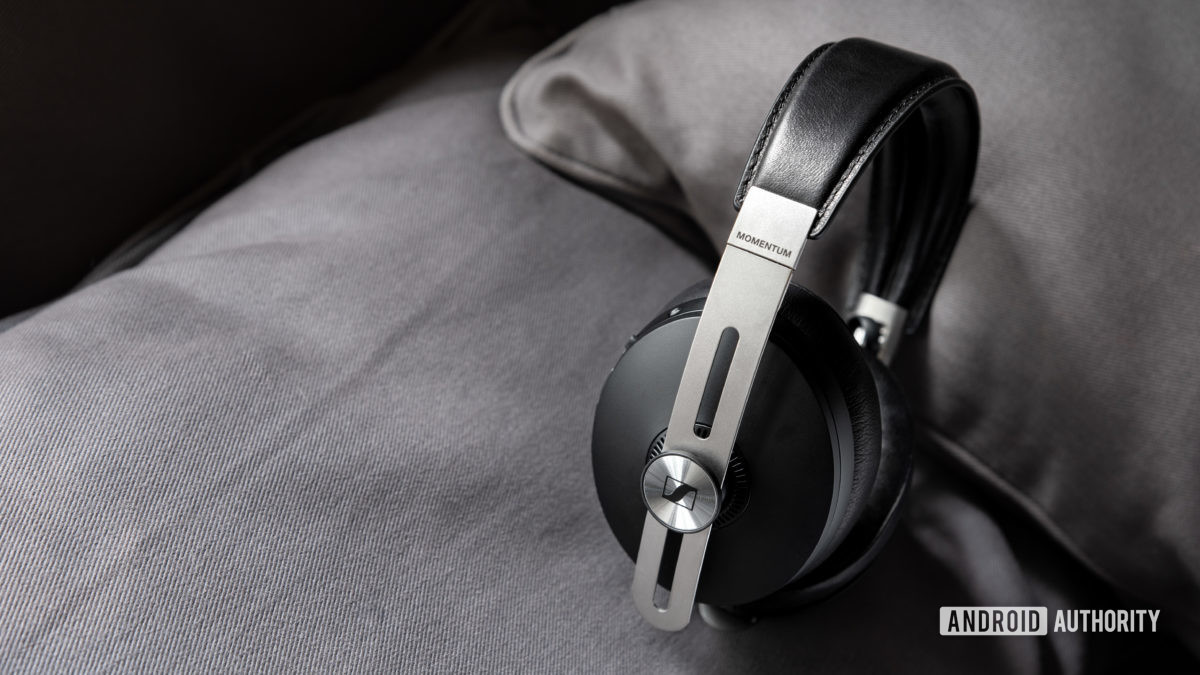 The Sennheiser Momentum Wireless 3 Bluetooth headphones in black rest against a gray surface.