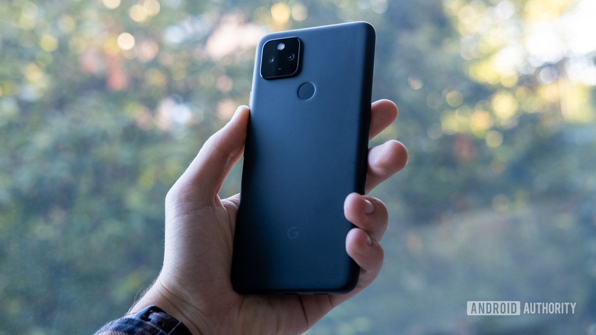 Holding Google Pixel 4a 5G on the back of the phone