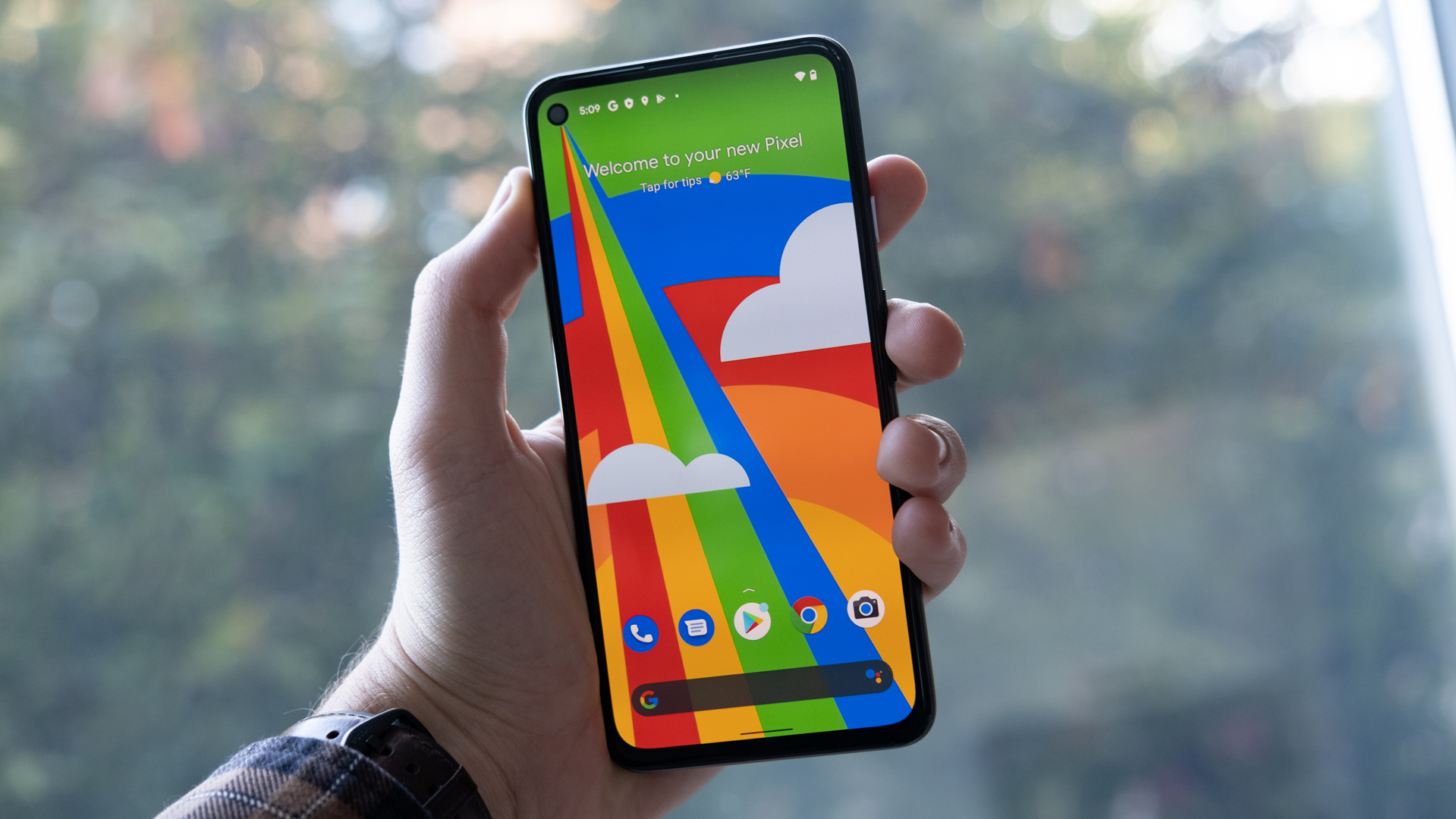 Google Pixel 4a 5G in hand showing the display.