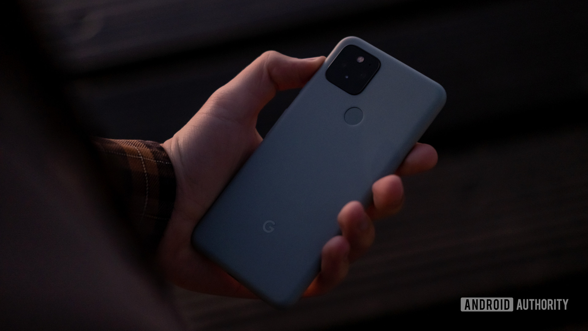 Google Pixel 5 holding in hand facing down 1