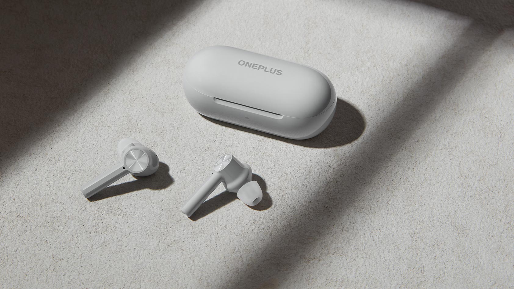 A photo of the OnePlus Buds Z lifestyle true wireless earbuds in off-white against a matching off-white background.