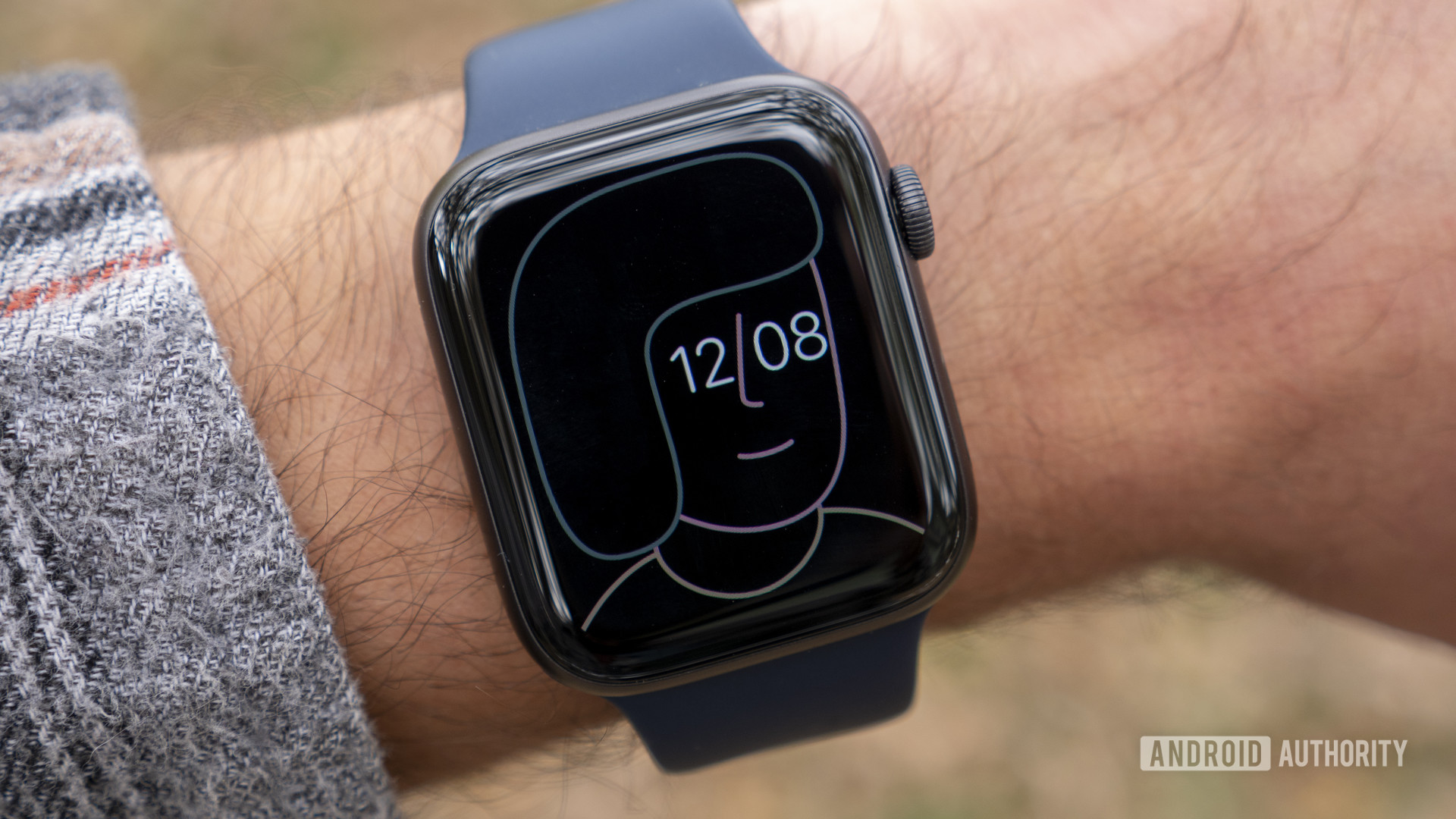 A user wears an Apple Watch Series 6 on his wrist displaying the Artist watch face.